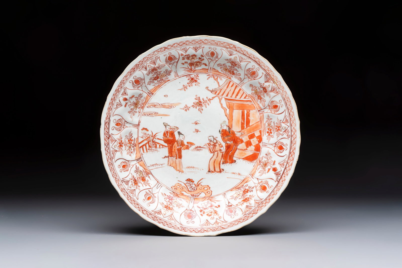 A Chinese iron-red and gilt-decorated 'Xi Xiang Ji' plate, Kangxi (1 of 2)