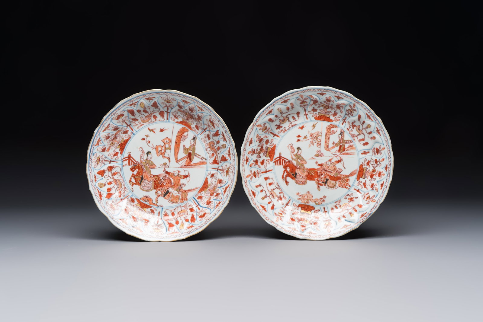 A pair of Chinese gilt iron-red-decorated 'Falconry' plates, Kangxi (1 of 2)