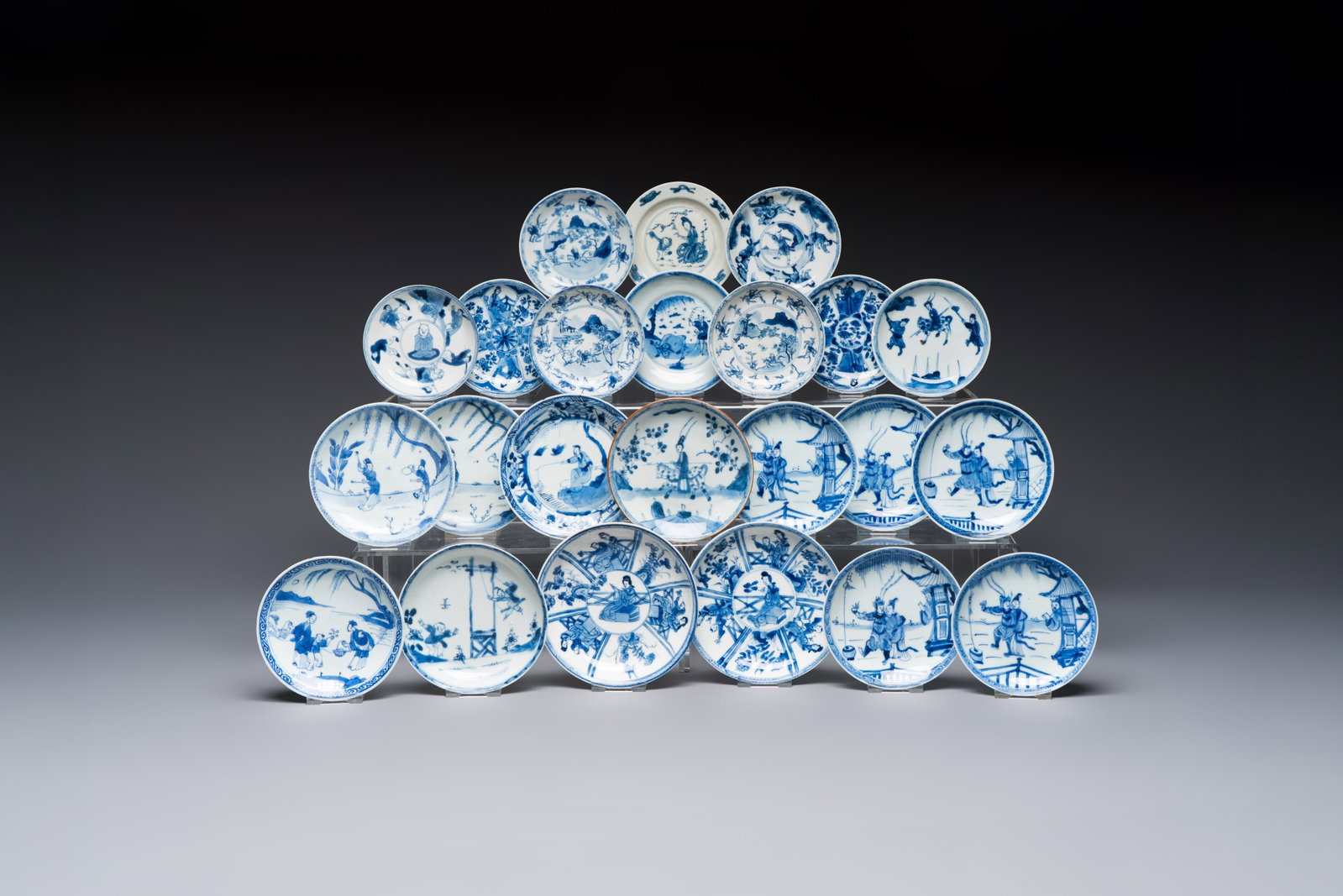 23 Chinese blue and white saucers with figural design, Yongzheng/Kangxi: 23 Chinese blue and white saucers with figural design, Yongzheng/Kangxi Dia.: 12,5 cm (the largest) Dia.: 9,8 cm (the smallest)