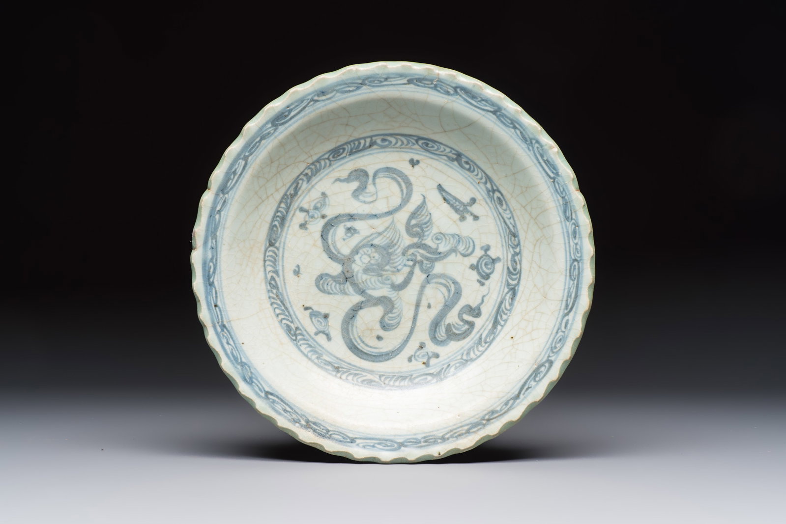 An unusual Chinese blue and white celadon-back 'Buddhist Lion' plate, Ming (1 of 2)