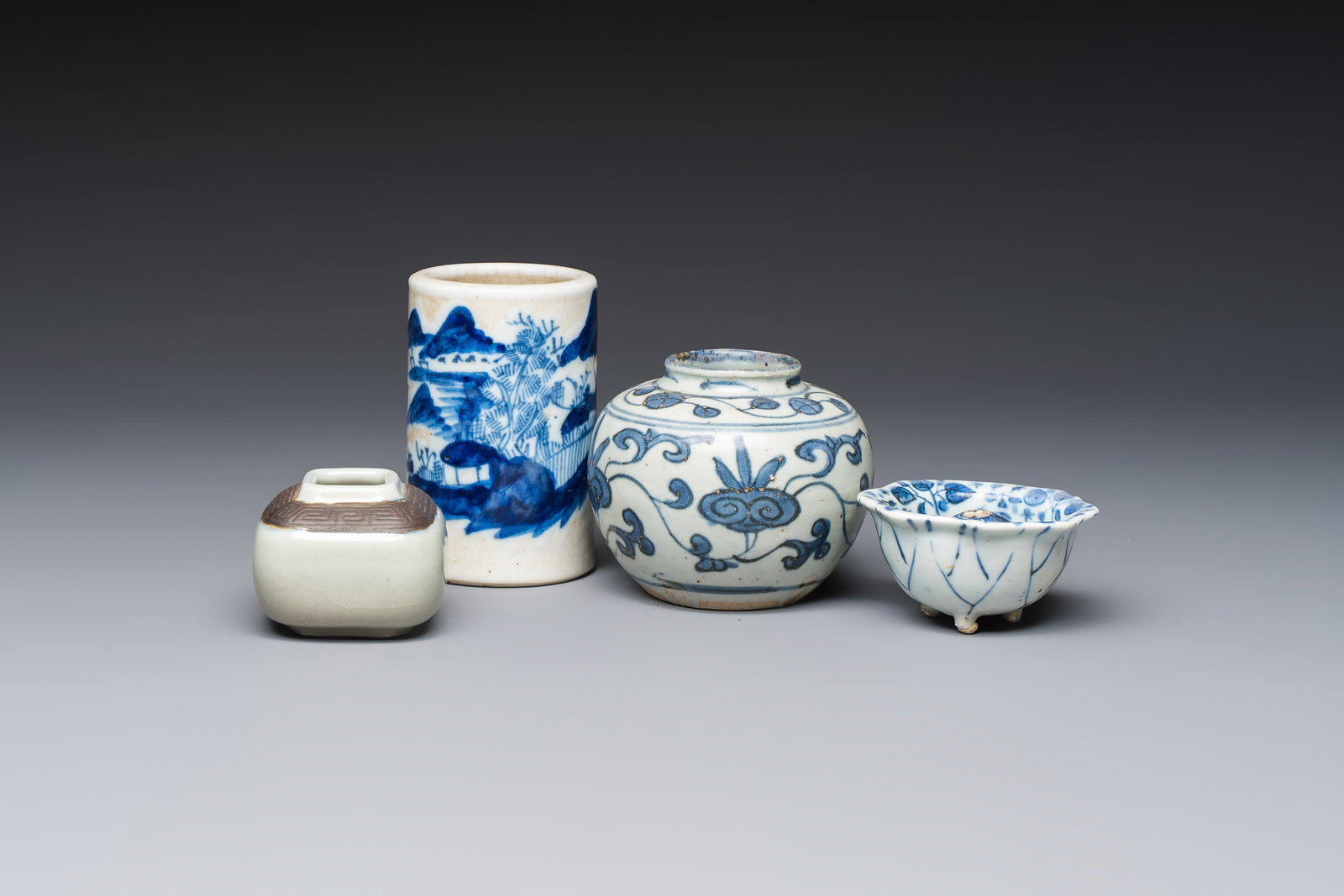 A Chinese Nanking water pot, a blue and white brush pot, a jarlet and a trick cup, Ming and later (1 of 13)