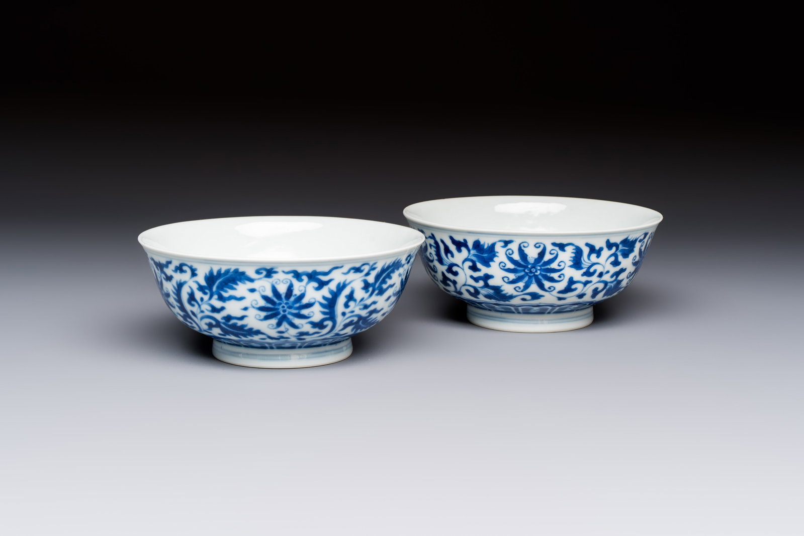 A pair of Chinese blue and white 'lotus scroll' bowls, Yongzheng mark and of the period (1 of 7)
