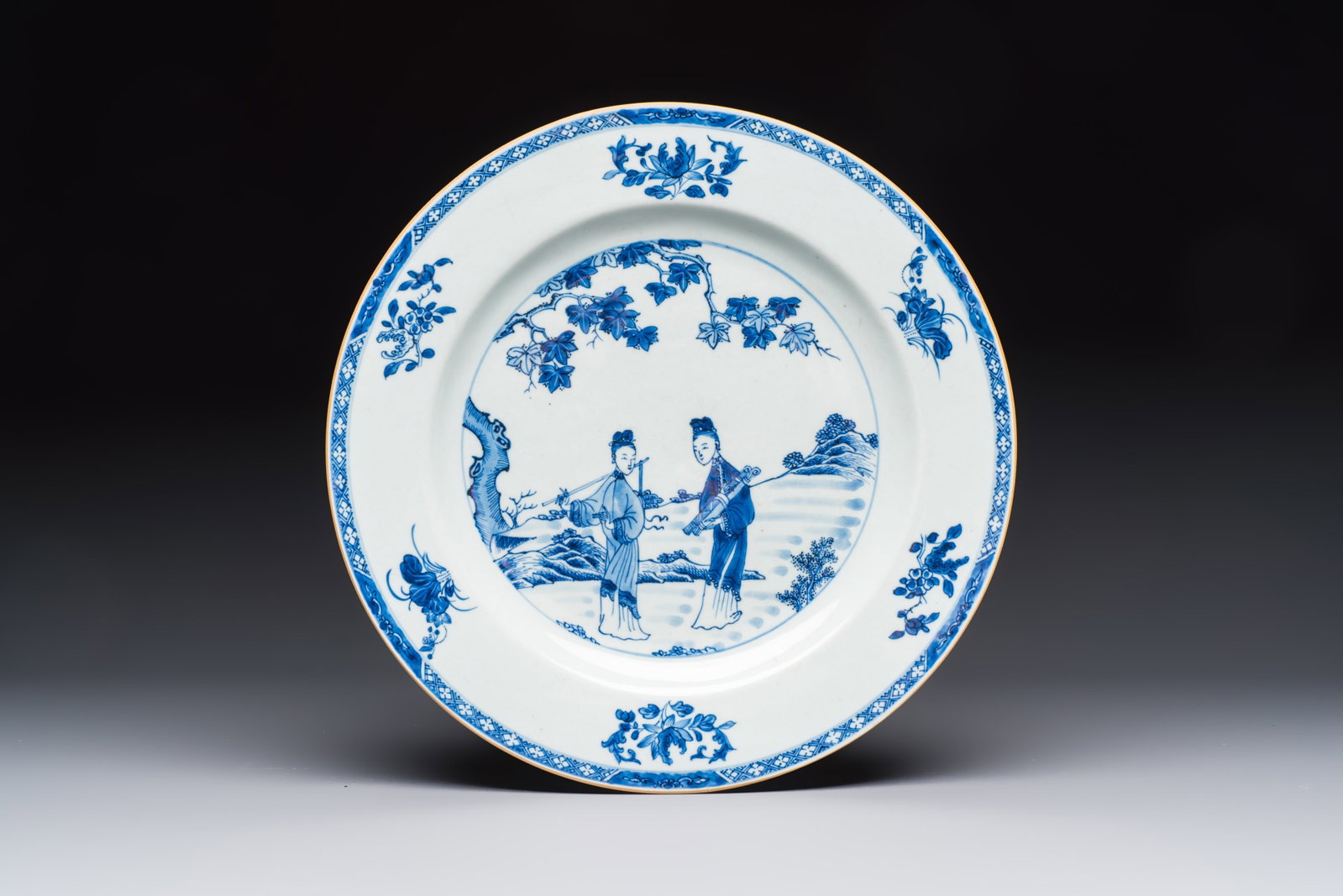 A Chinese blue and white 'Elegant Ladies in a Garden' dish, Qianlong: A Chinese blue and white 'Elegant Ladies in a Garden' dish, Qianlong Dia.: 32,2 cm