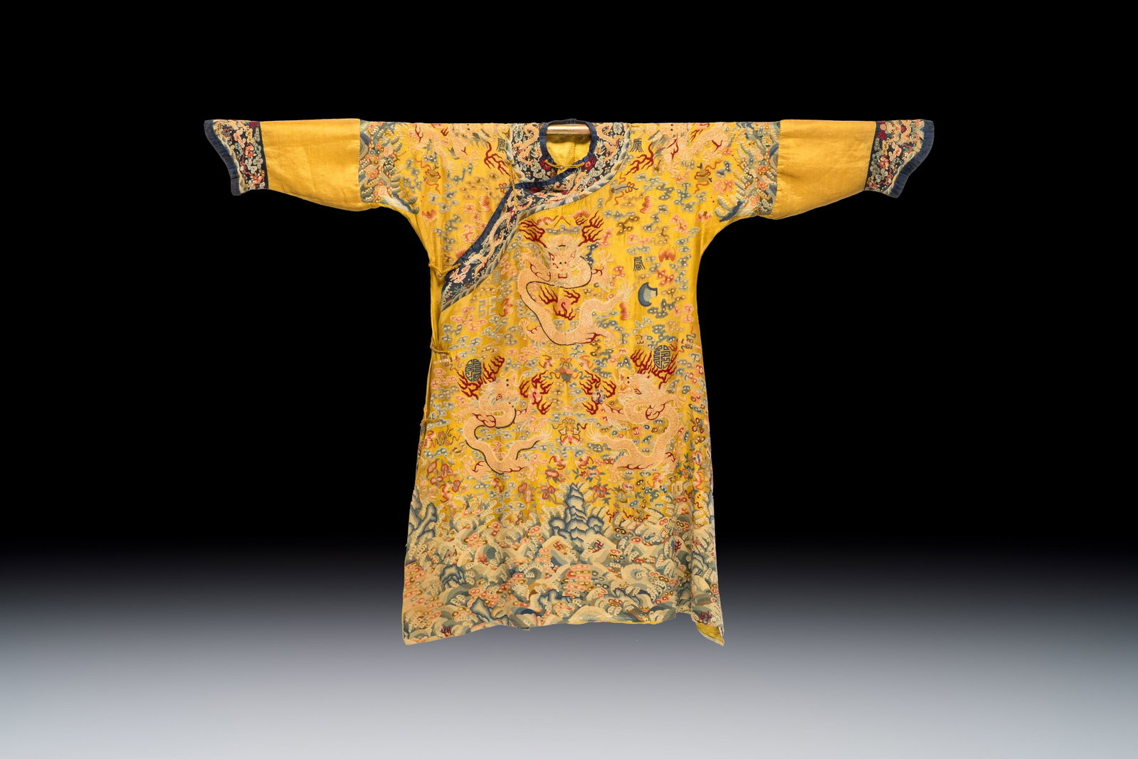 A Chinese imperial yellow-ground embroidered silk 'Nine Symbols' lady's 'Dragon' robe, 'Ji Fu', 19th (1 of 2)