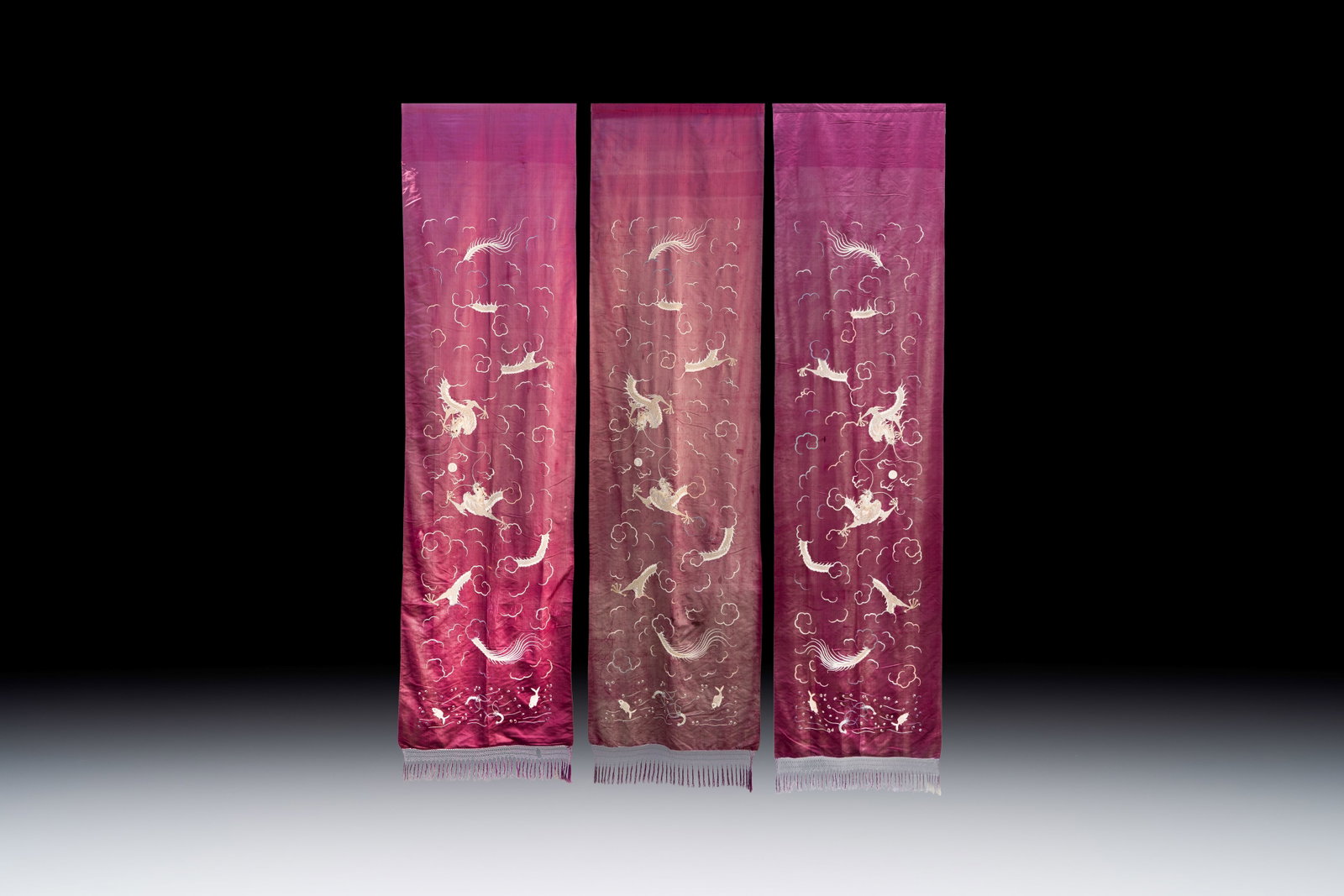Three large Chinese purple-ground embroidered silk 'Dragons among Clouds' panels, 19th C. (1 of 2)