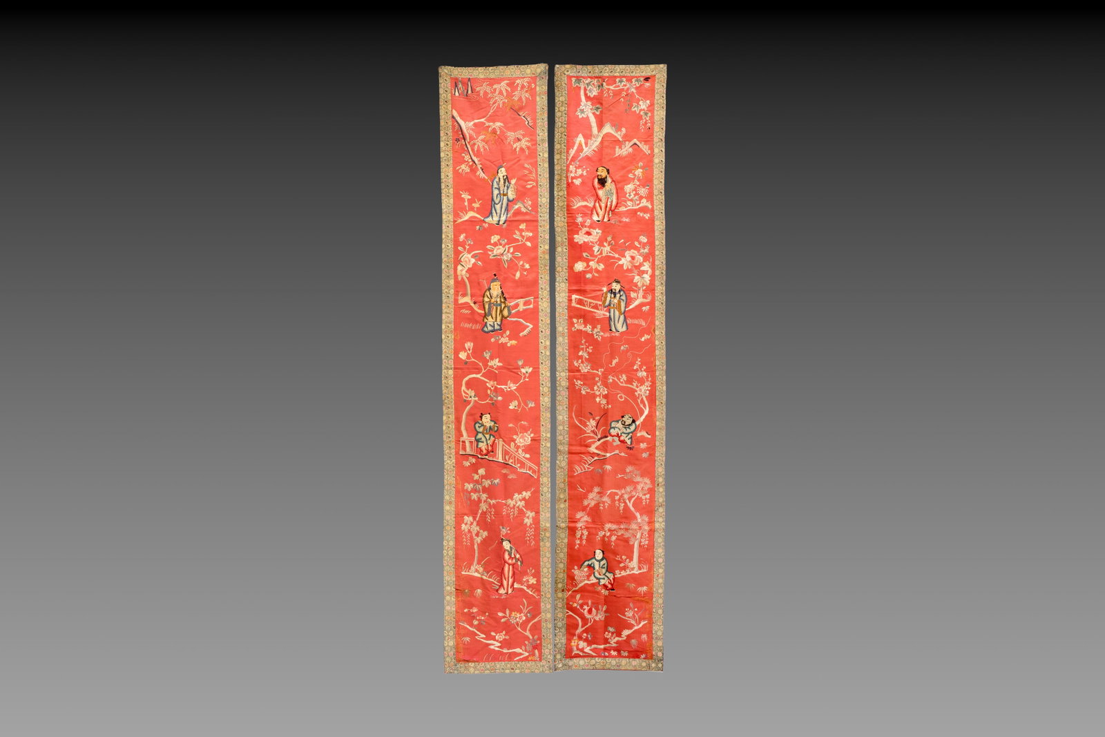 A pair of Chinese red-ground embroidered silk 'Eight Immortals' panels, 19th C. (1 of 3)
