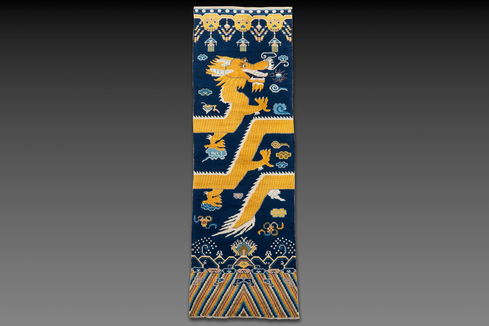 A Sino-Tibetan woollen 'Dragon' pillar carpet, 19th C. (1 of 5)