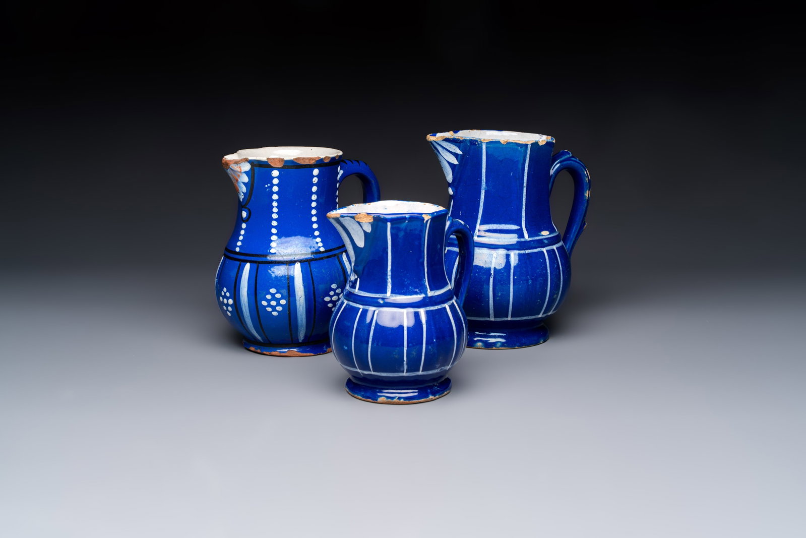 Three blue-ground faience jugs, probably Saint-Omer, North of France, 18/19th C. (1 of 7)