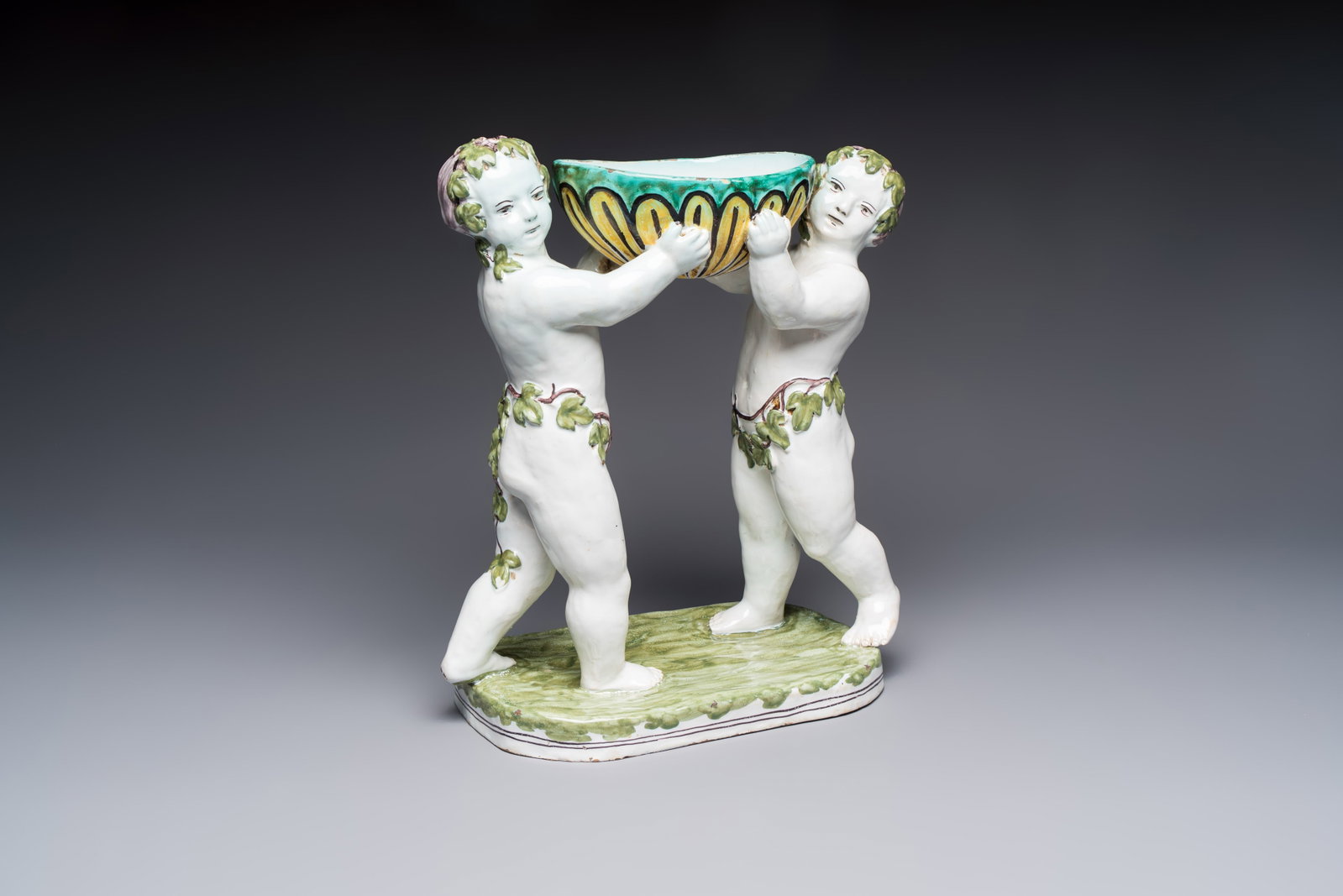 A French polychrome faience group with two Bacchus figures, Geo Martel, Dèsvres, early 20th C. (1 of 7)