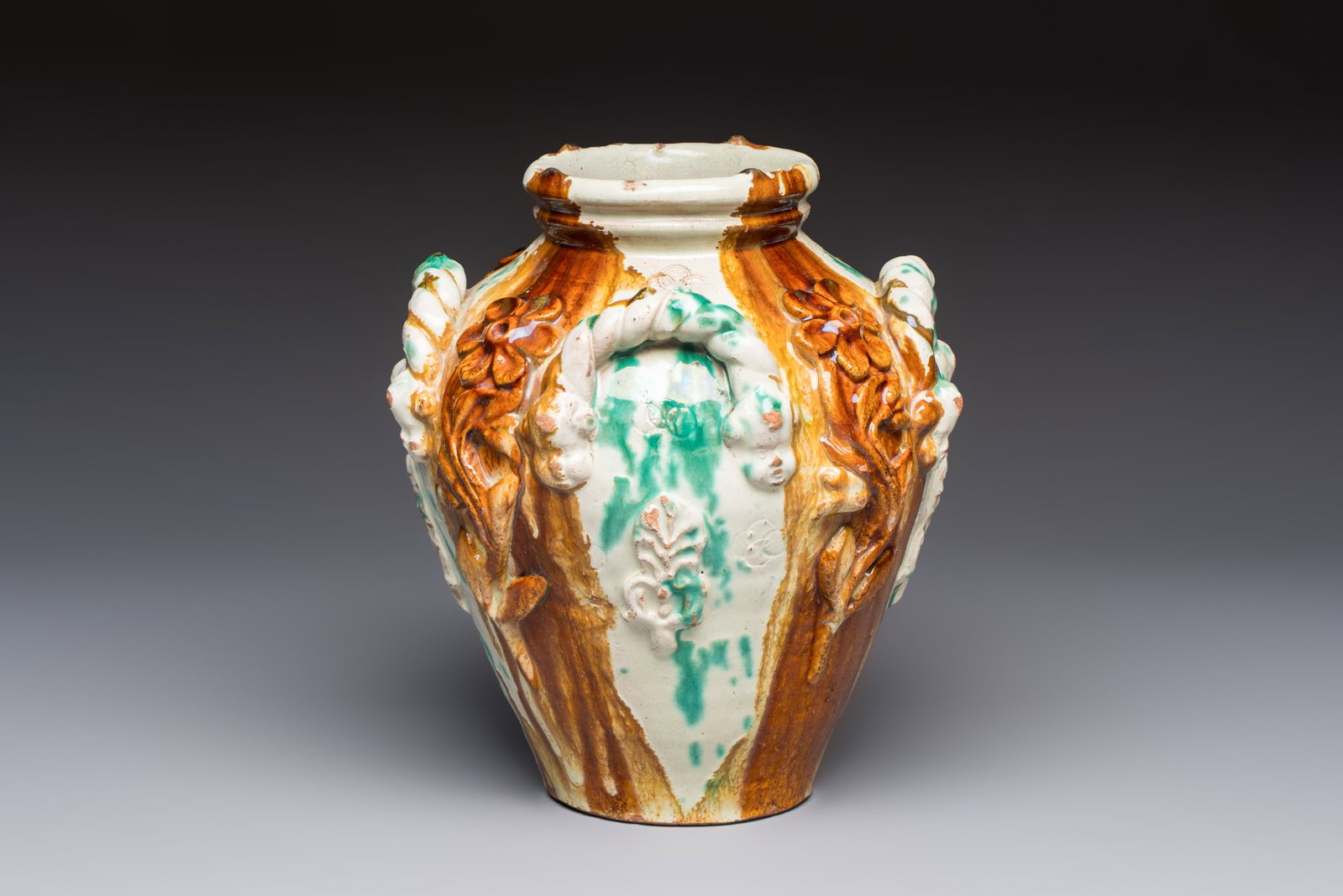A polychrome Saintonge pottery vase with rope twist handles and mascarons, France, 17th C. (1 of 7)