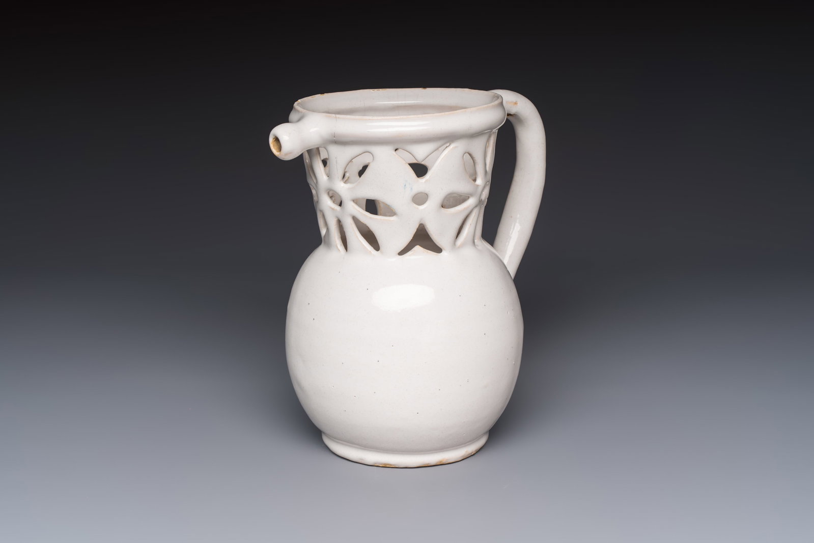 A French white-glazed puzzle jug, Nevers, 18th C. (1 of 7)