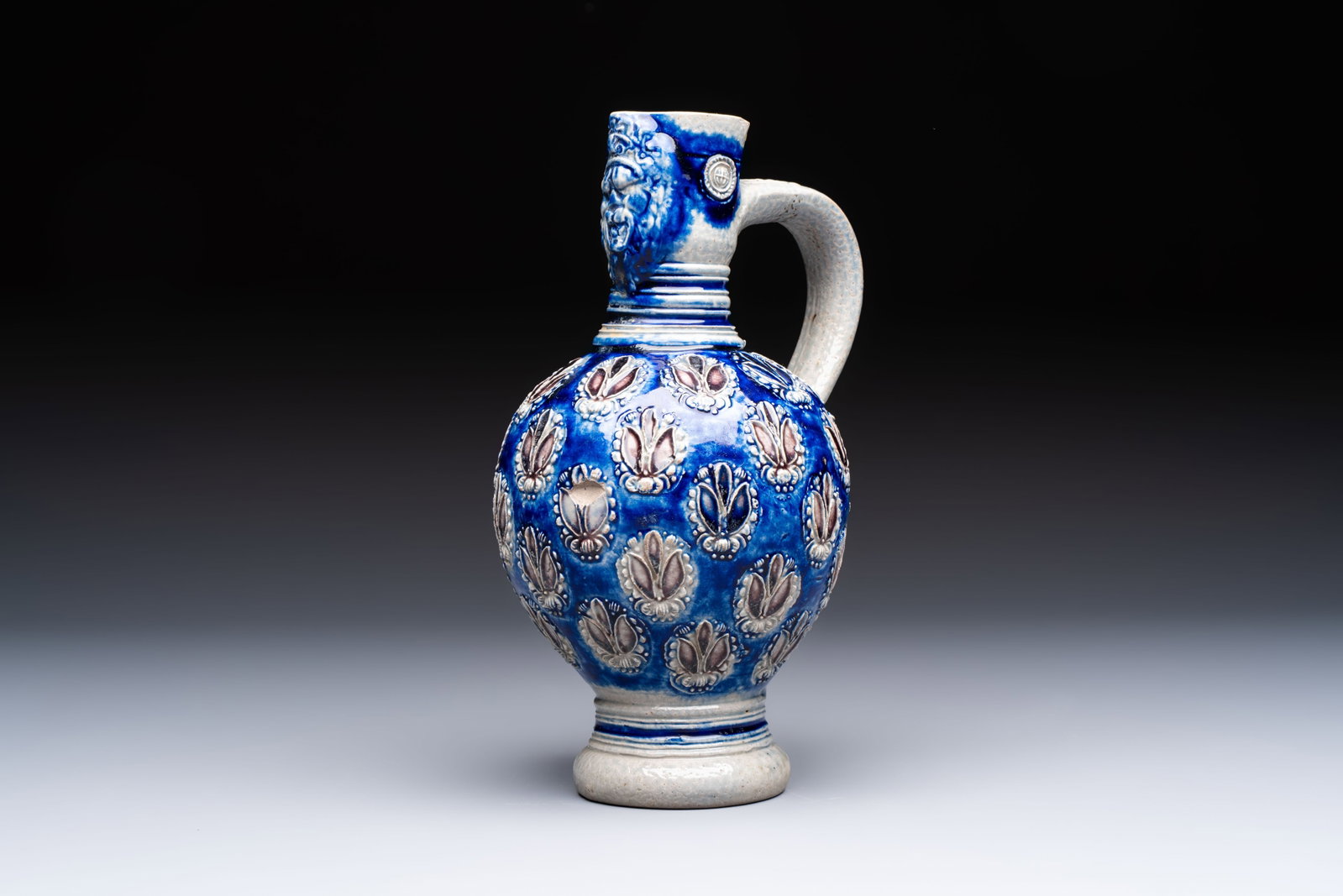 A Westerwald stoneware jug with a lion's head and moulded floral design, Germany, 17th C. (1 of 7)