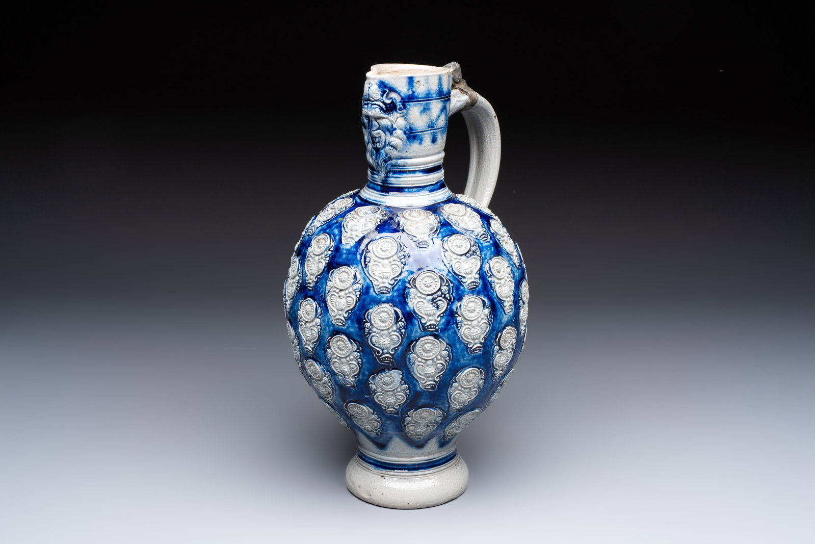 A Westerwald stoneware jug with a lion's head and moulded floral design, Germany, 17th C. (1 of 7)