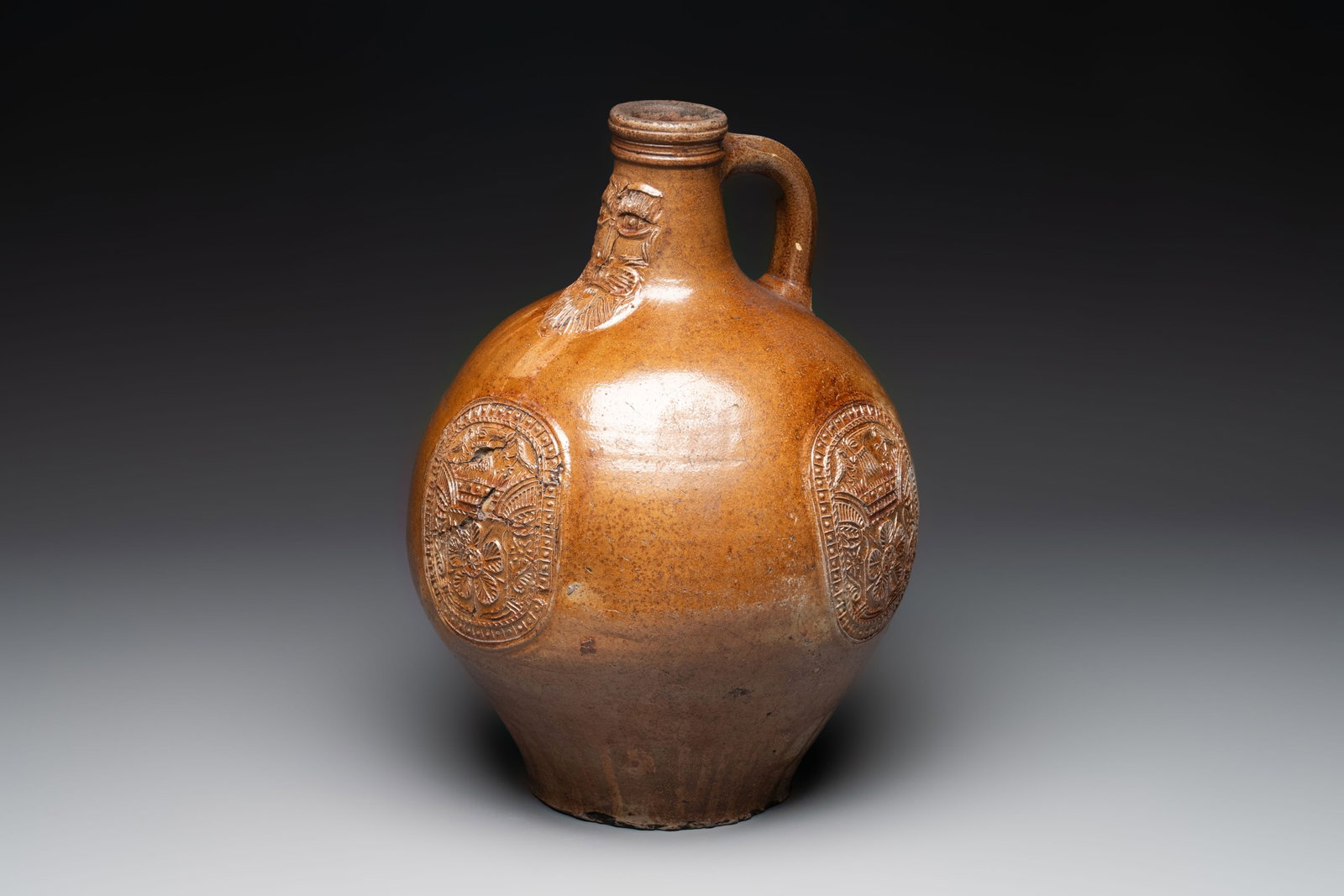 A large brown-glazed stoneware bellarmine jug, 17th C. (1 of 7)