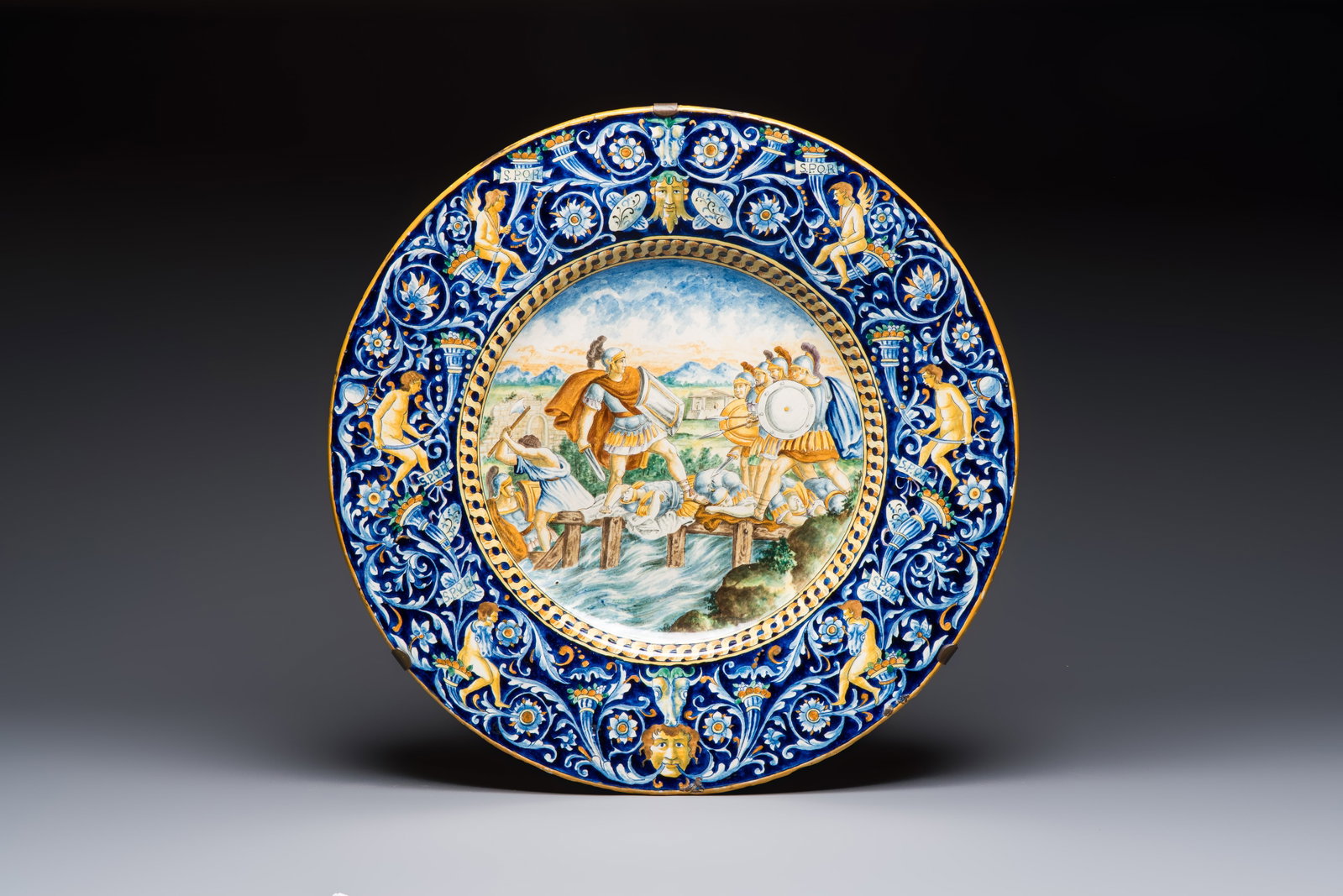 A massive polychrome Italian maiolica istoriato charger with a classical battle scene, 19th C. (1 of 2)
