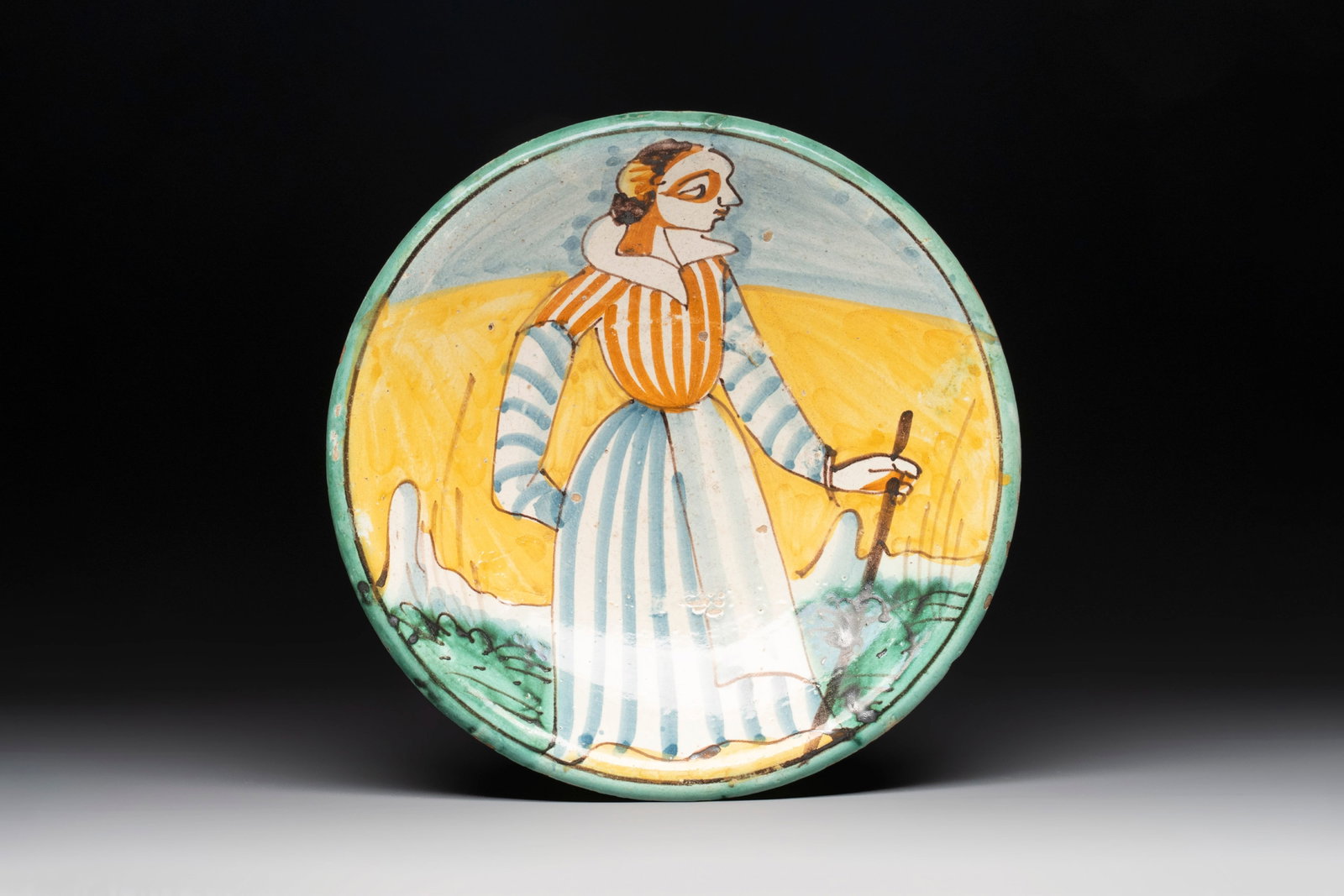 An Italian maiolica dish with a lady, Montelupo, 17th C. (1 of 2)