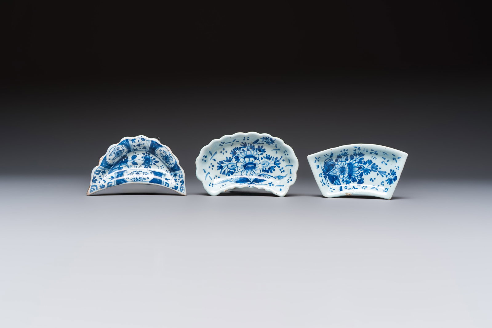 Two blue and white English Delftware condiment plates and a German Nürnberg example, 18th C. (1 of 2)