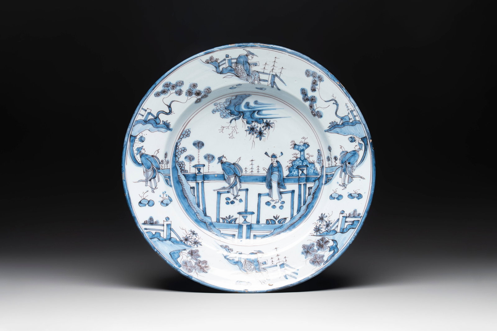 A blue and white 'figures in a garden' chinoiserie dish, Frankfurt, 17th C.: A blue and white 'figures in a garden' chinoiserie dish, Frankfurt, 17th C. Dia.: 39,5 cm