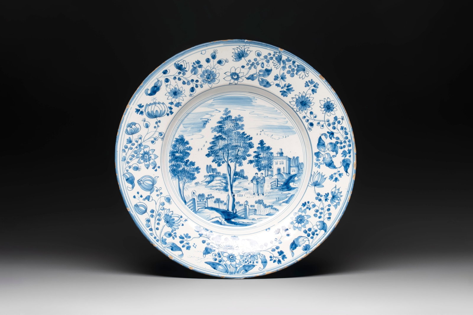A large blue and white 'landscape and figures' dish, Frankfurt, 17th C. (1 of 2)