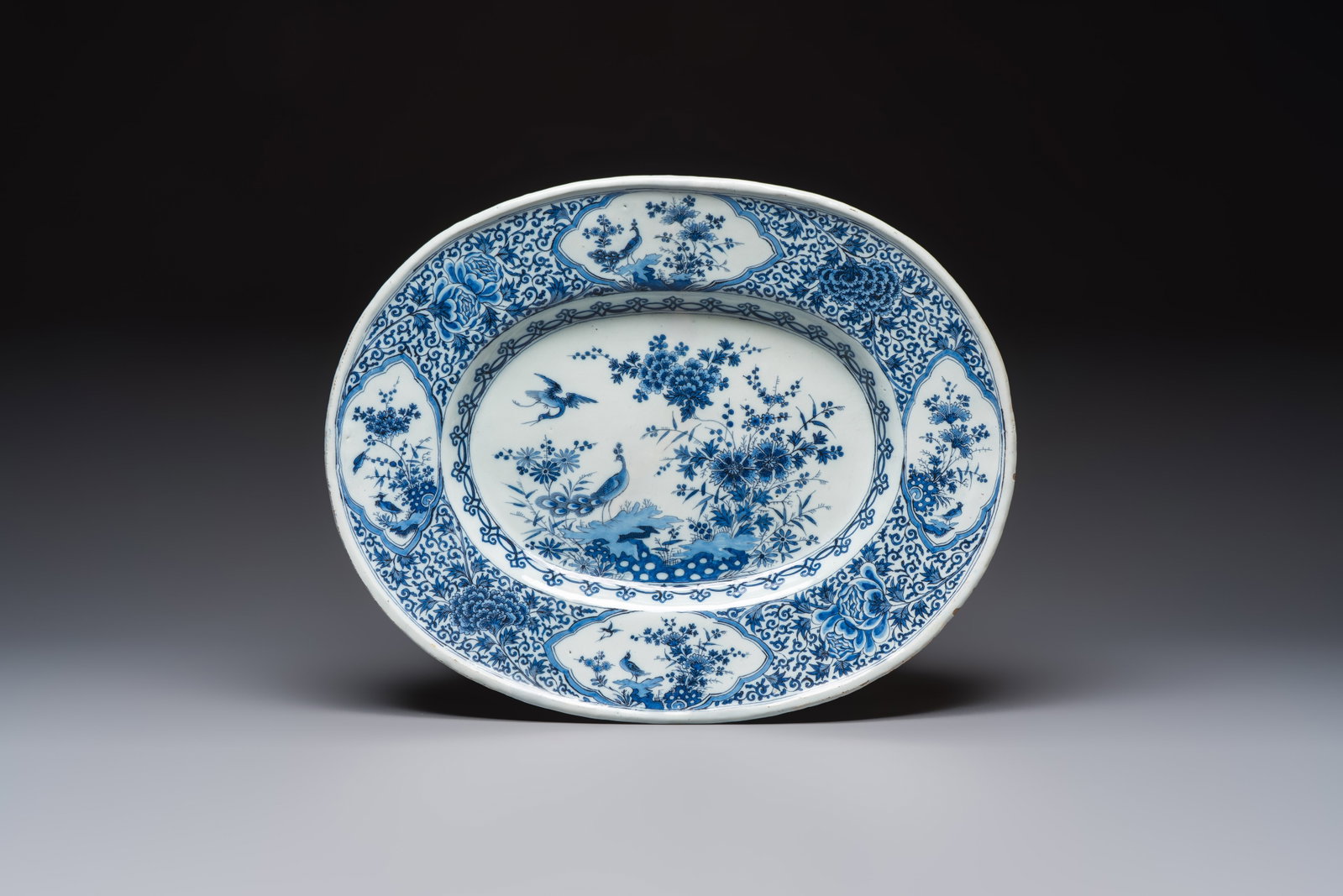 A very rare and massive blue and white Dutch Delft dish with peacocks in a garden, late 17th C. (1 of 2)