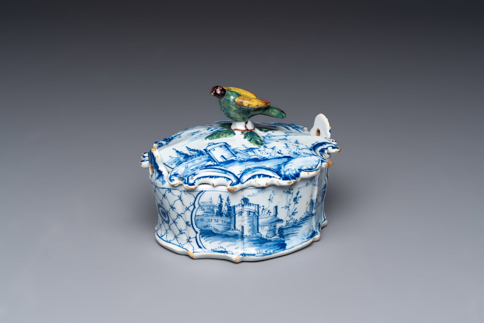 A blue and white Dutch Delft butter tub with a polychrome bird-shaped finial, 18th C. (1 of 9)