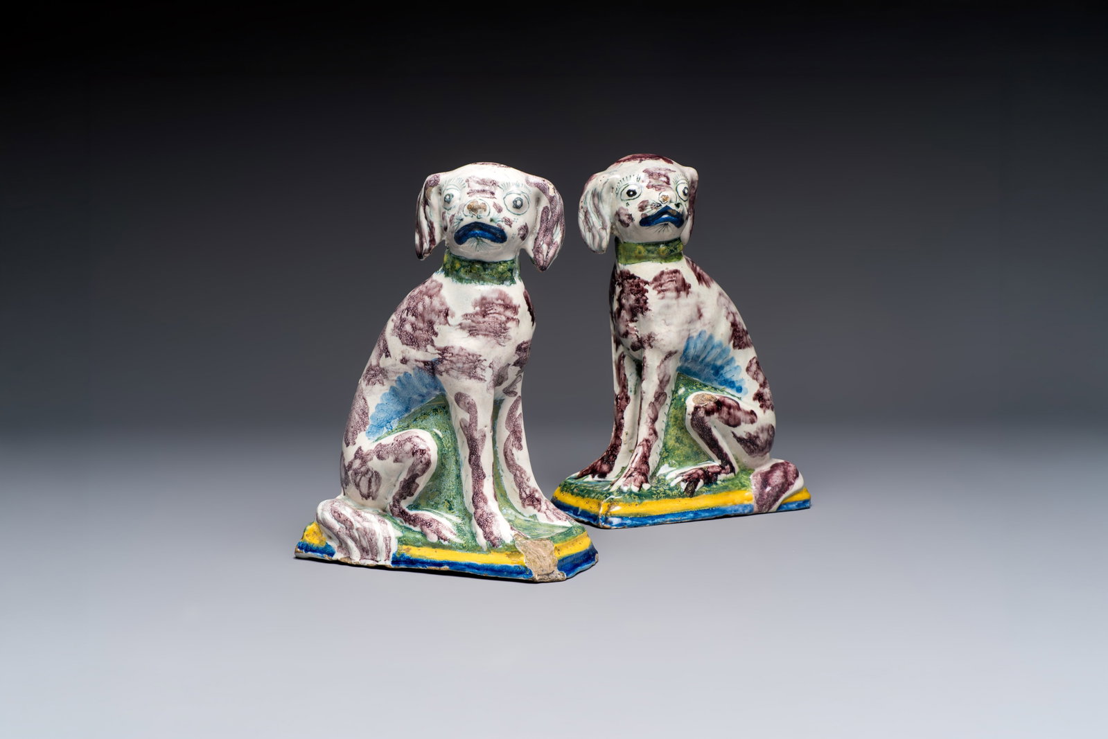 A pair of polychrome Dutch Delft money banks modelled as dogs, 18th C. (1 of 7)