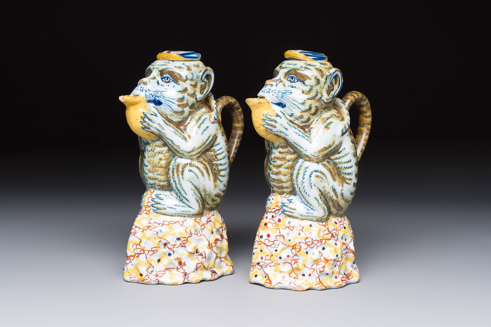 A pair of polychrome Dutch Delft monkey ewers and covers, 18th C. (1 of 7)
