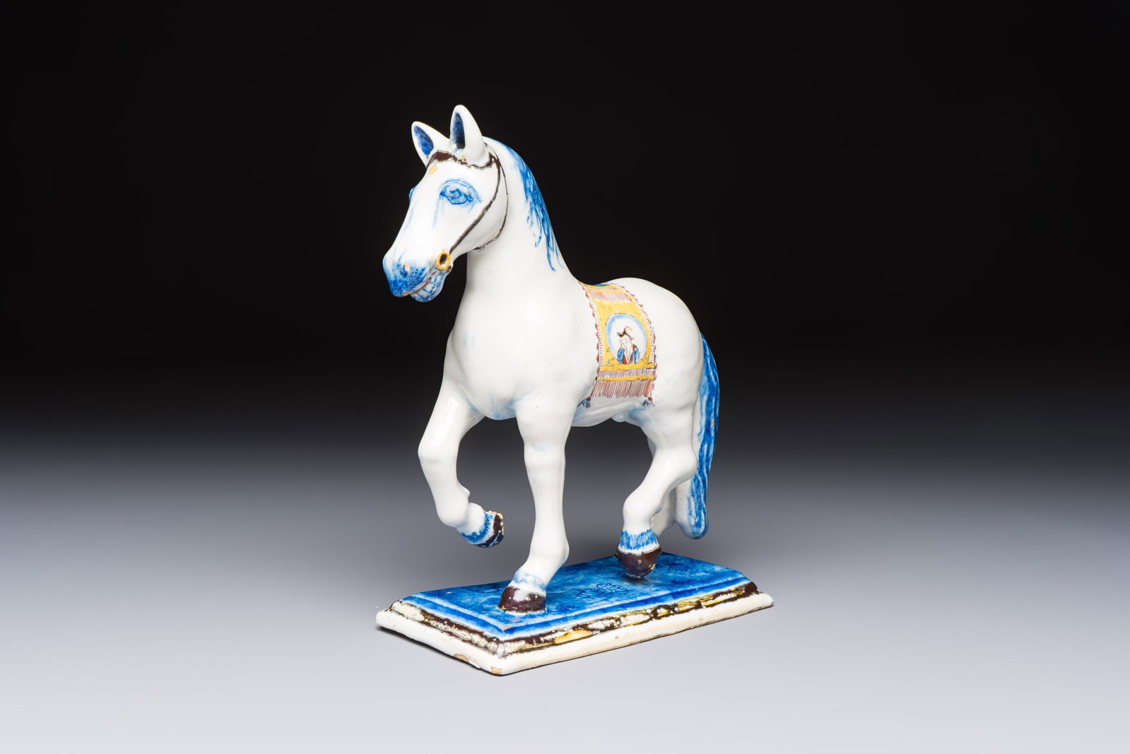A polychrome Dutch Delft model of a standing horse with a figurative saddle cloth, 18th C. (1 of 7)