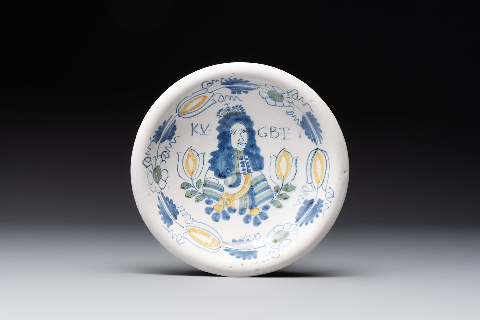 A rare polychrome Dutch Delft 'King William' dish, inscribed 'KV GBT', 17th C. (1 of 2)