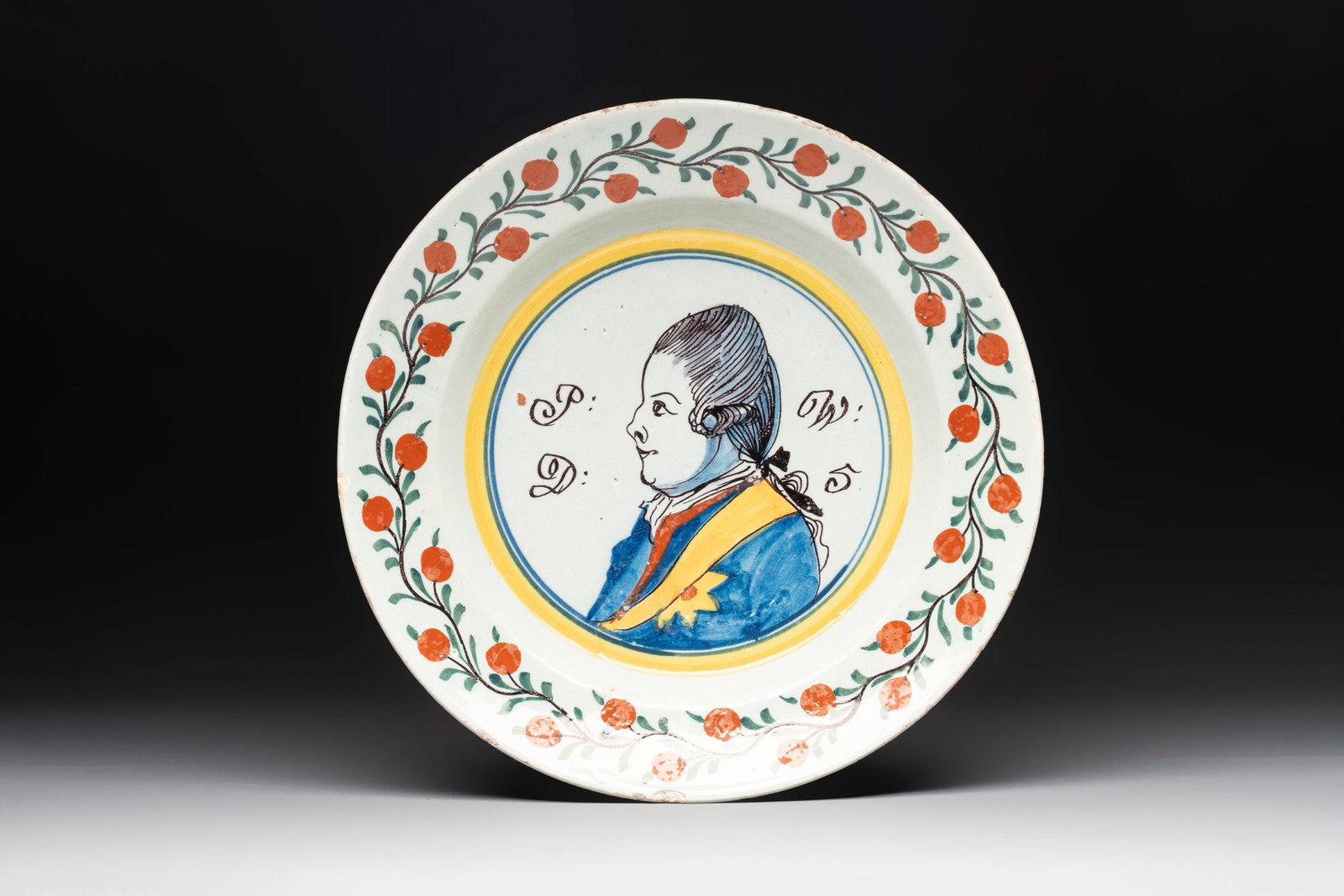 A polychrome Dutch Delft 'orangist' 'royal portrait' plate, 18th C. (1 of 2)