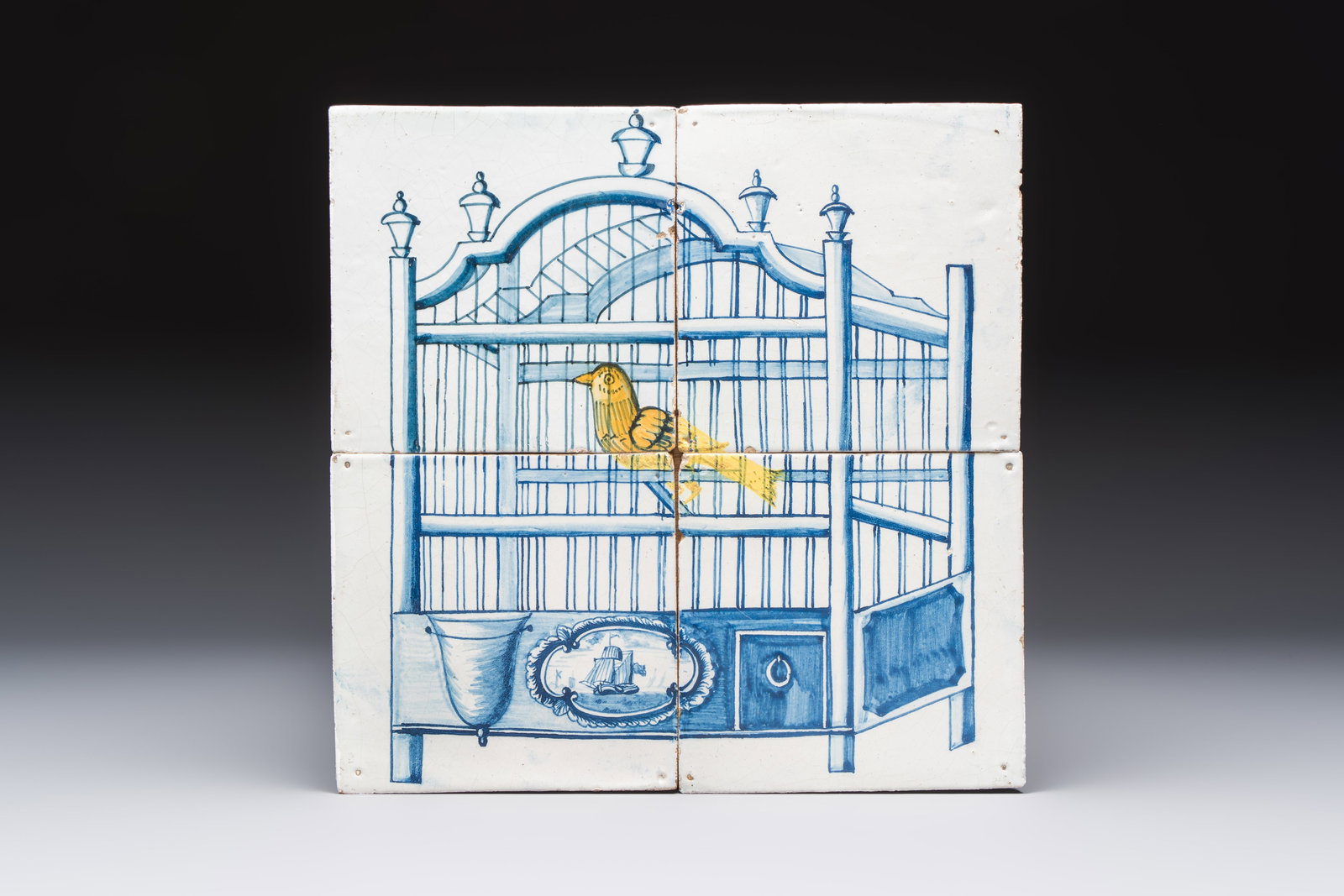 A polychrome Dutch Delft four-tile panel with a canary in a cage, 18th C. (1 of 2)