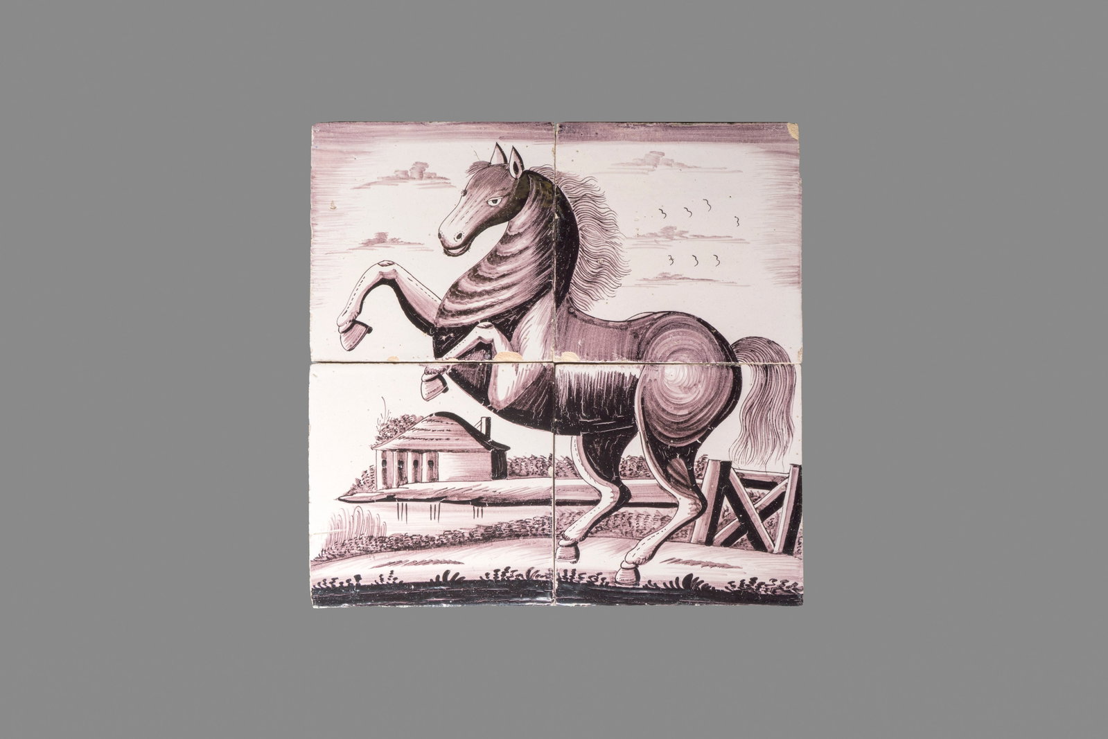 A manganese Dutch Delft four-tile panel with a rearing horse, 18th C. (1 of 2)