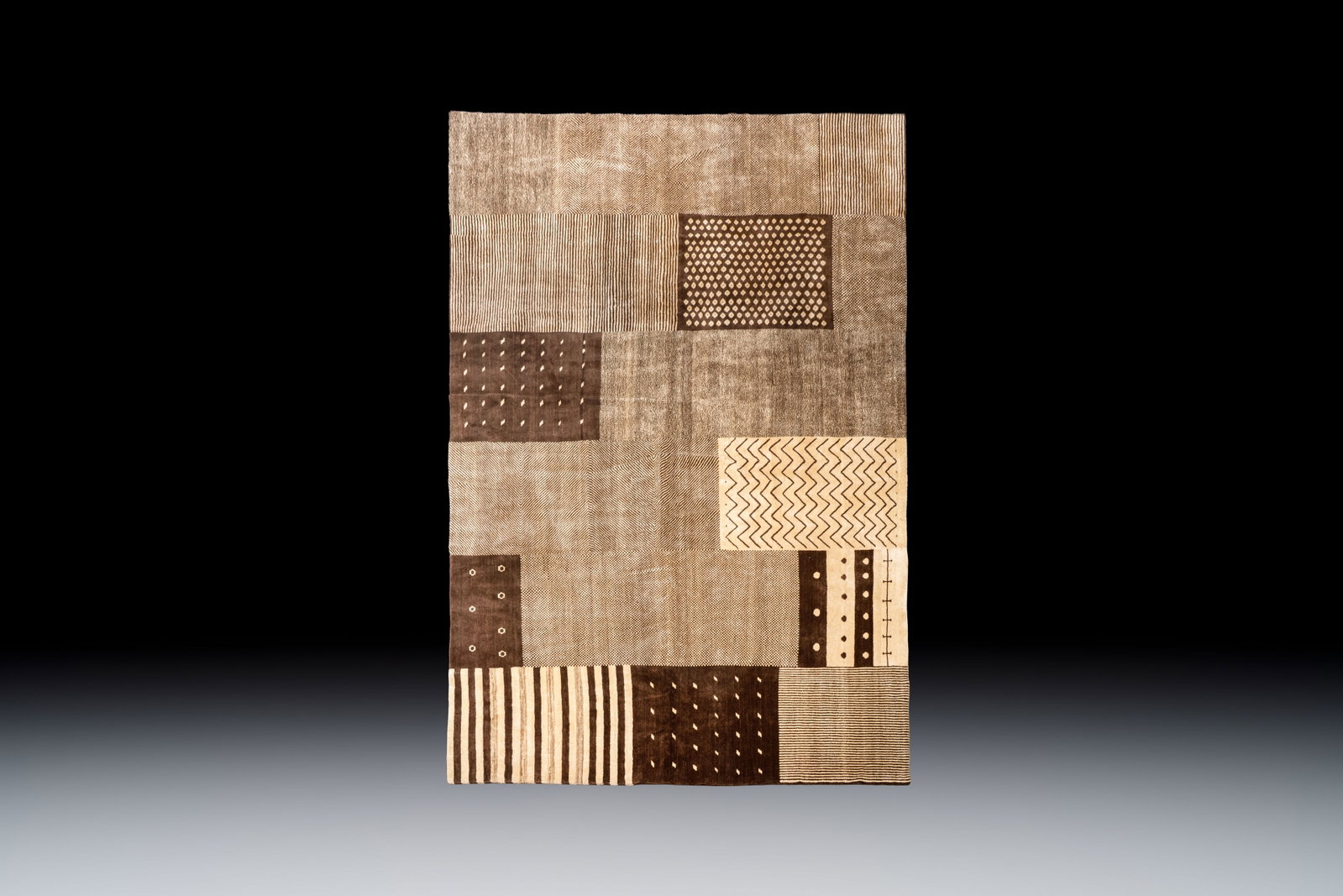 A large Persian hand-knotted woollen carpet with a geometric patchwork design, 20th C.: A large Persian hand-knotted woollen carpet with a geometric patchwork design, 20th C. Dim.: 456 x 265 cm Provenance: - A private Belgian collection. - Acquired from NEW TOWN TRADING COMPANY LIMITED, 