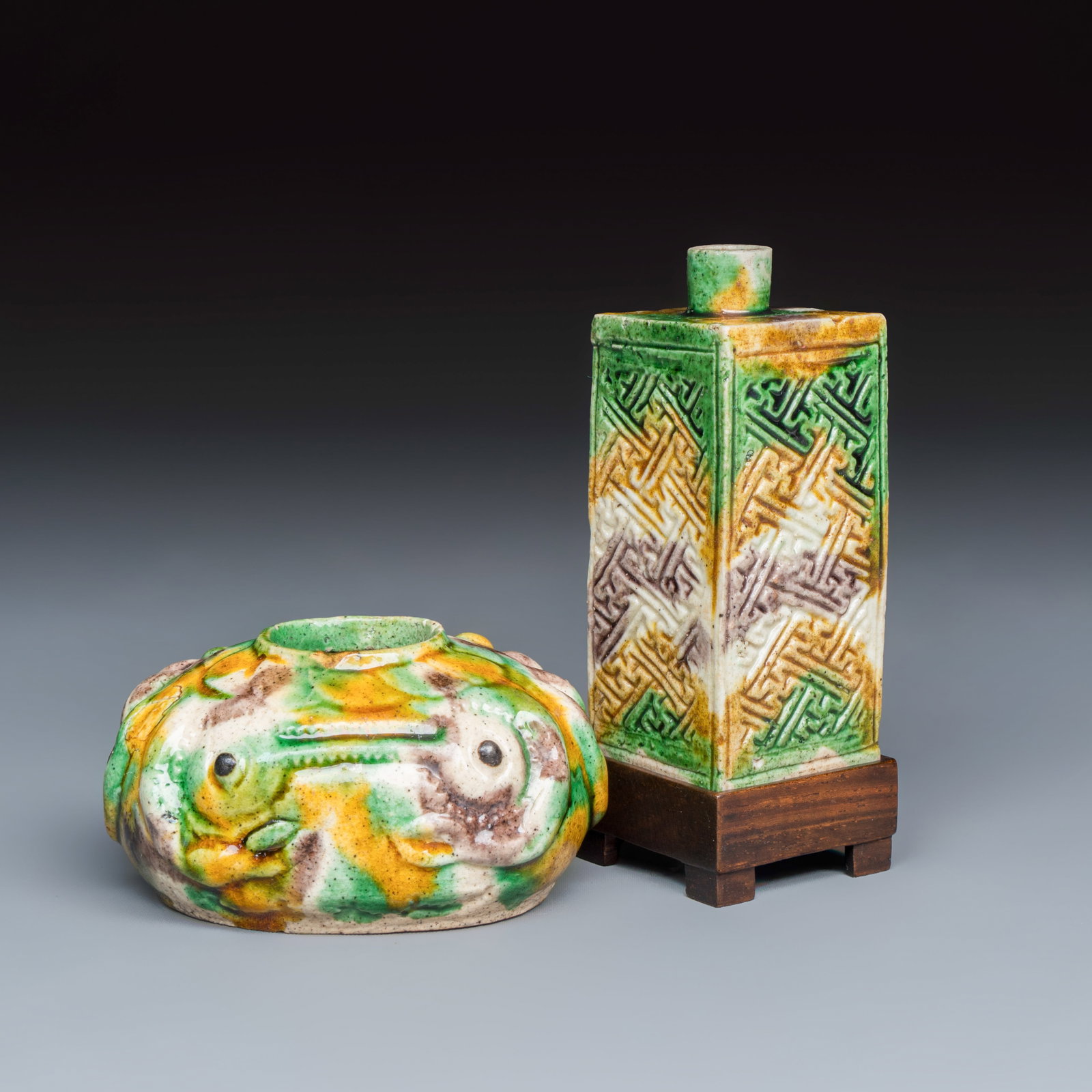 A Chinese famille verte sancai biscuit 'Crab' water pot and a 'Swastika' square bottle on a later (1 of 9)