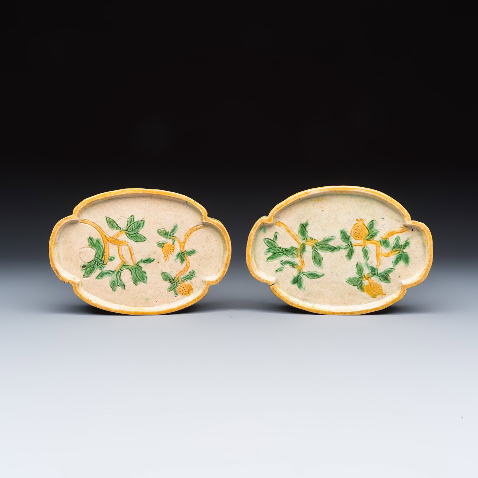 A pair of Chinese sancai-glazed stoneware quadrilobed trays with fruiting branches, Ming (1 of 2)
