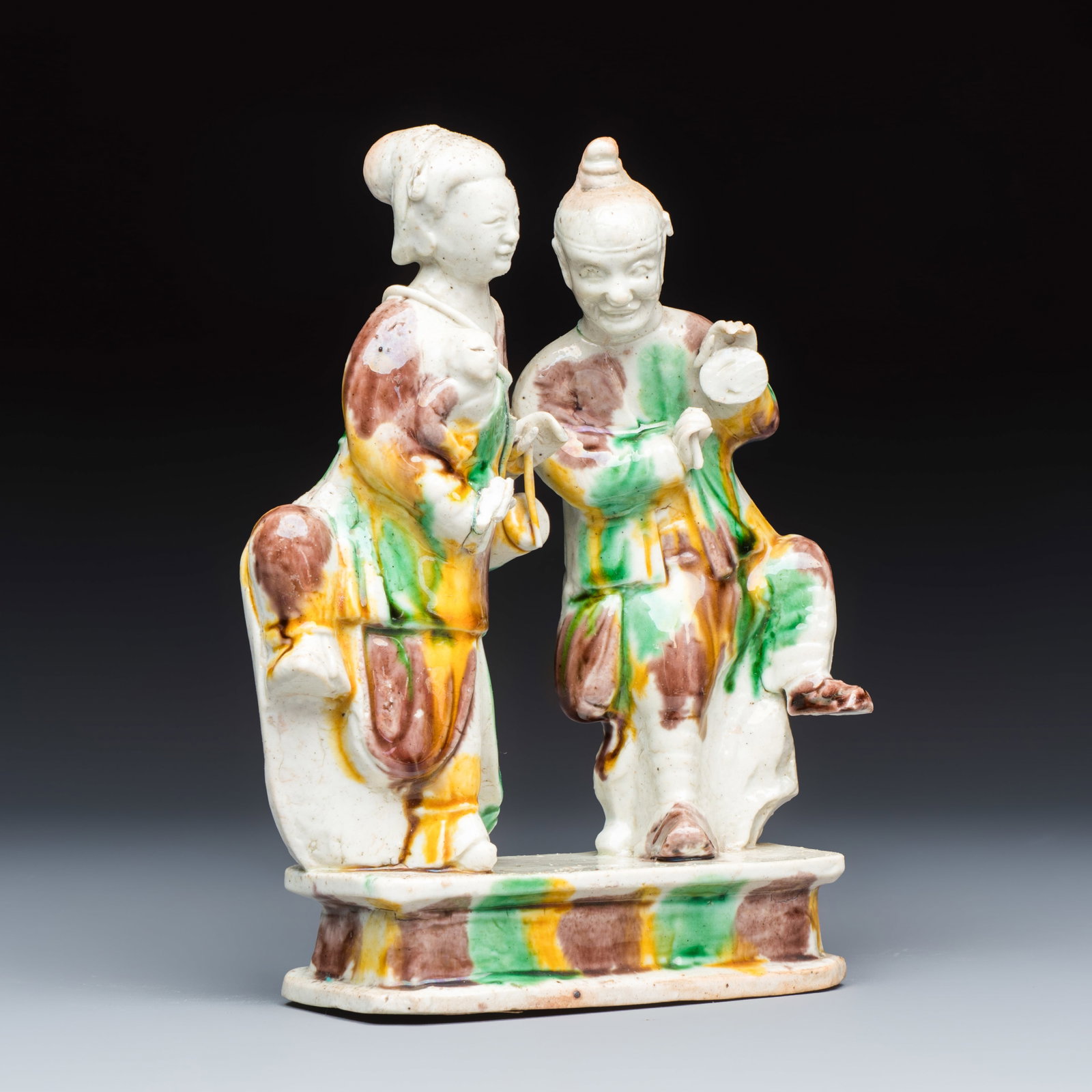 A Chinese famille verte sancai biscuit 'Merry Music Making' group, Kangxi (1 of 7)