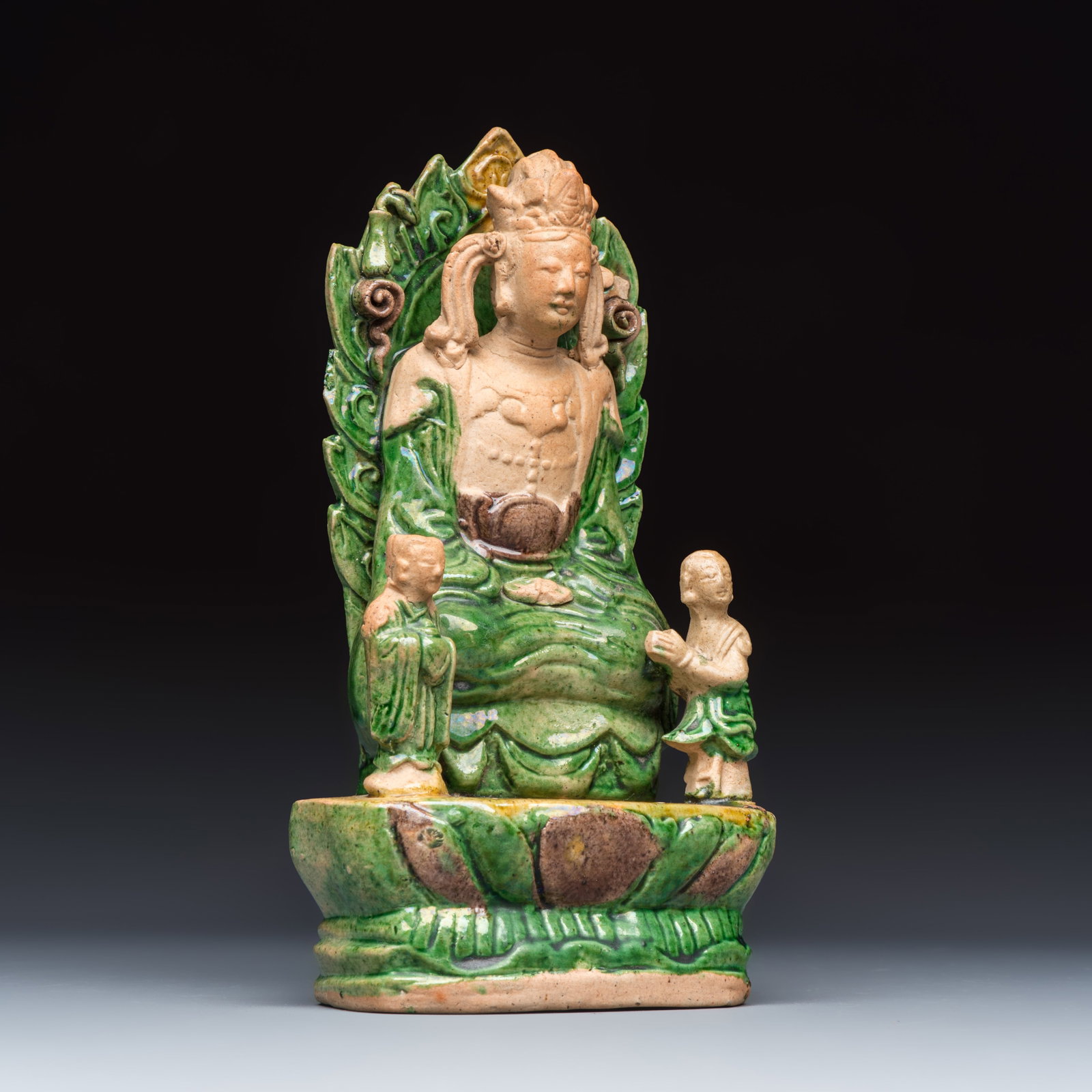 A Chinese sancai-glazed stoneware group of Guanyin and two attendants, Ming (1 of 7)