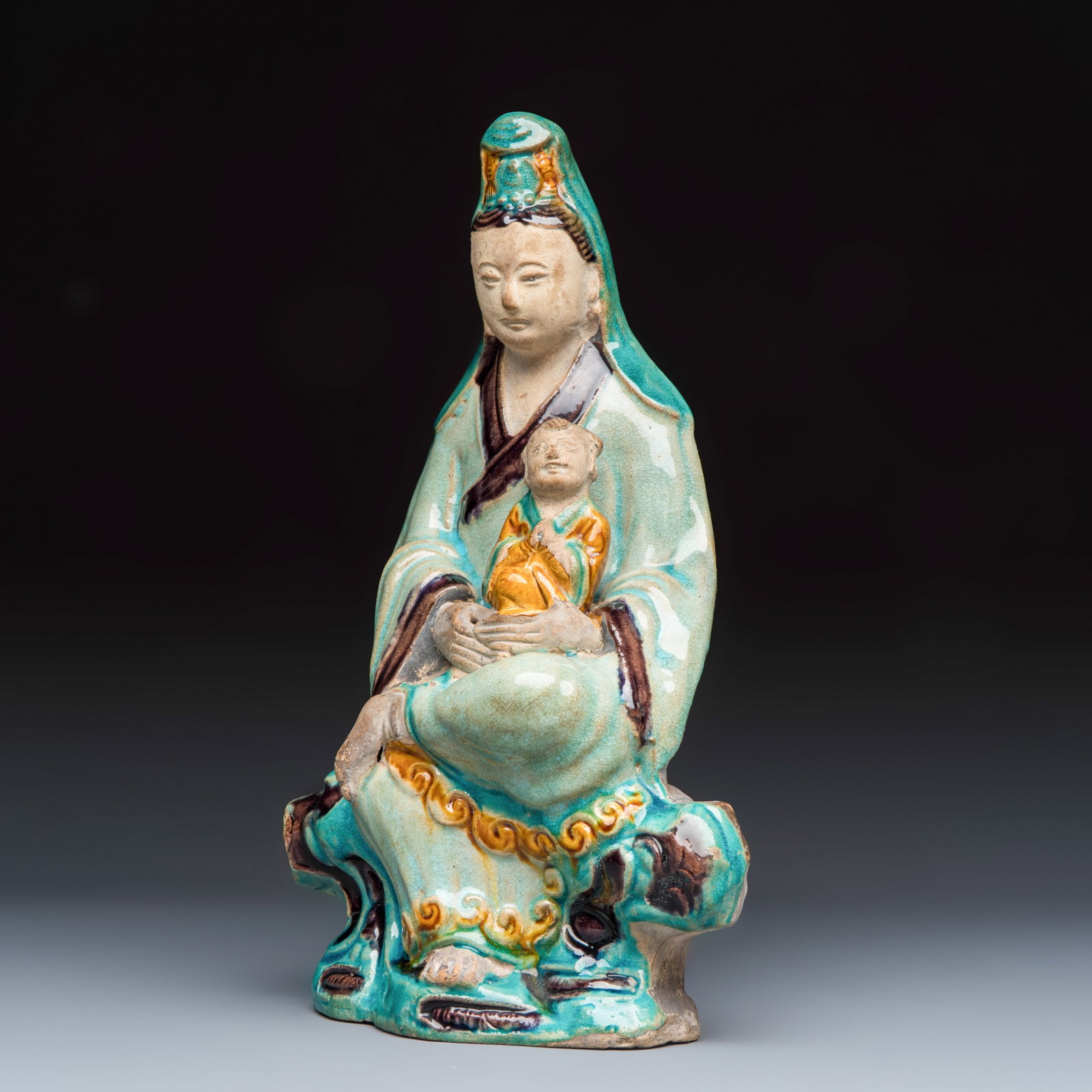 A Chinese Fahua-glazed stoneware 'Guanyin and Child' group, Ming (1 of 7)