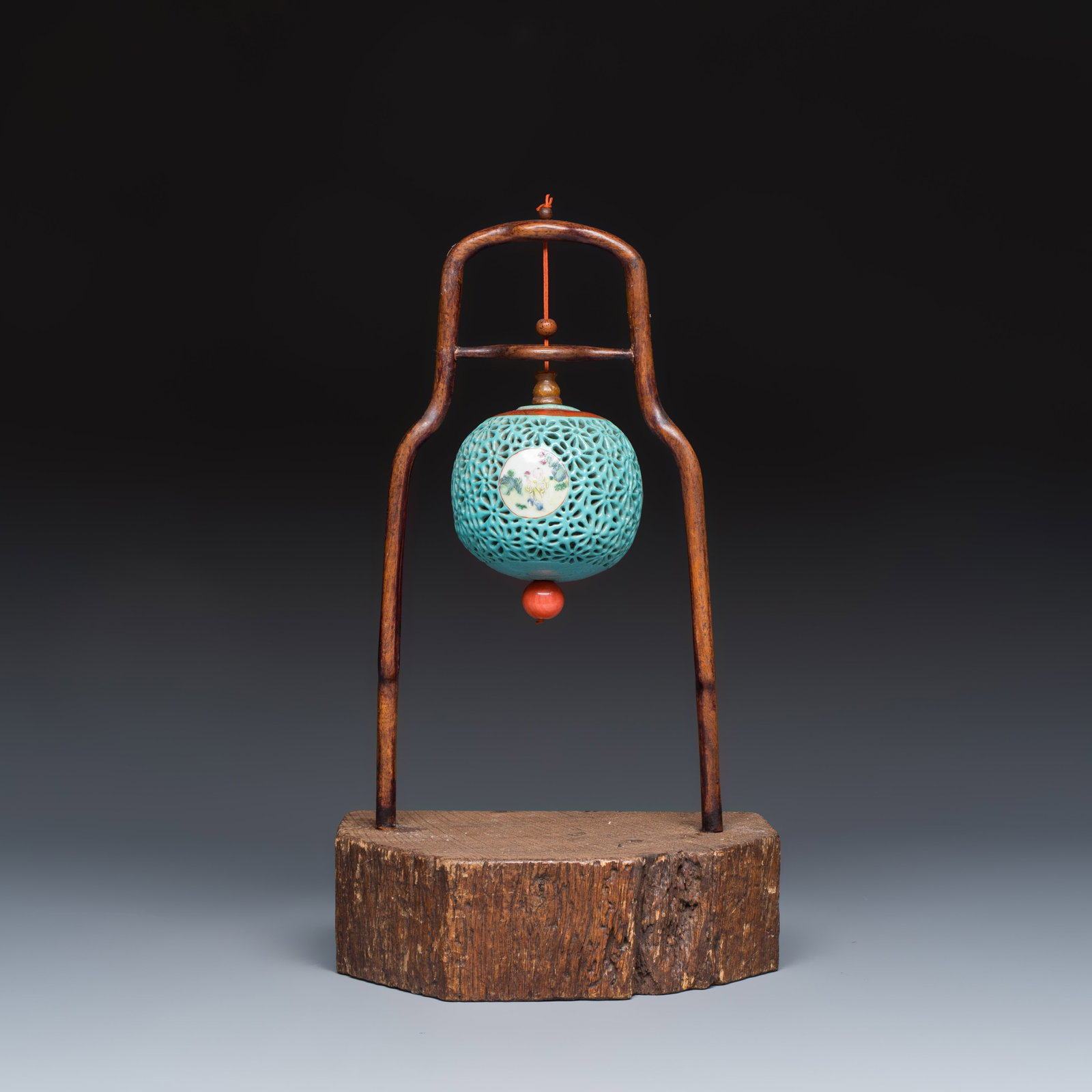 A Chinese famille rose turquoise-ground reticulated incense ball and cover, and a wooden stand,: A Chinese famille rose turquoise-ground reticulated incense ball and cover, and a wooden stand, Qianlong Dia.: 7,8 cm | the incense burner H.: 32,6 cm | the stand