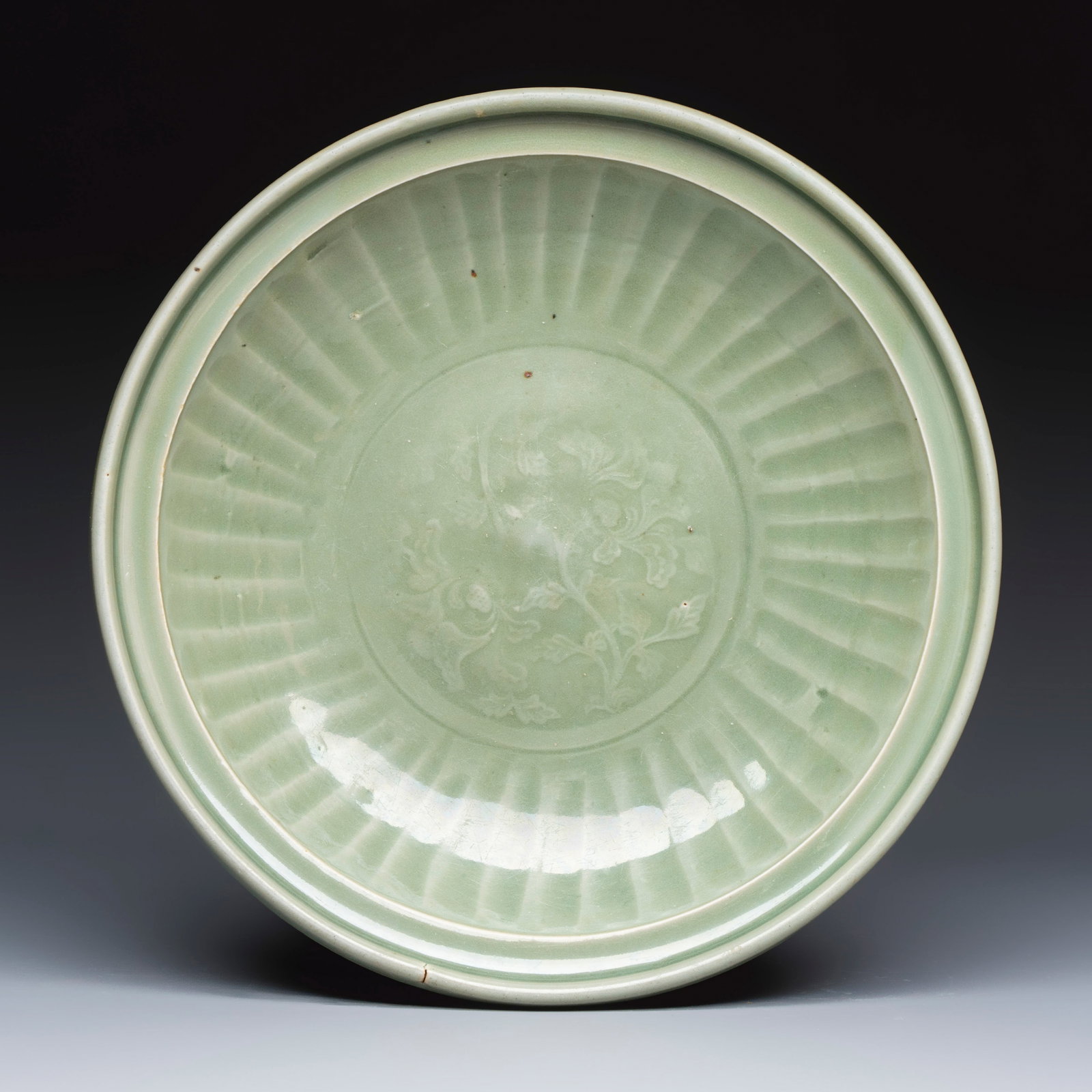 A Chinese Longquan celadon dish with incised floral design, Ming (1 of 2)