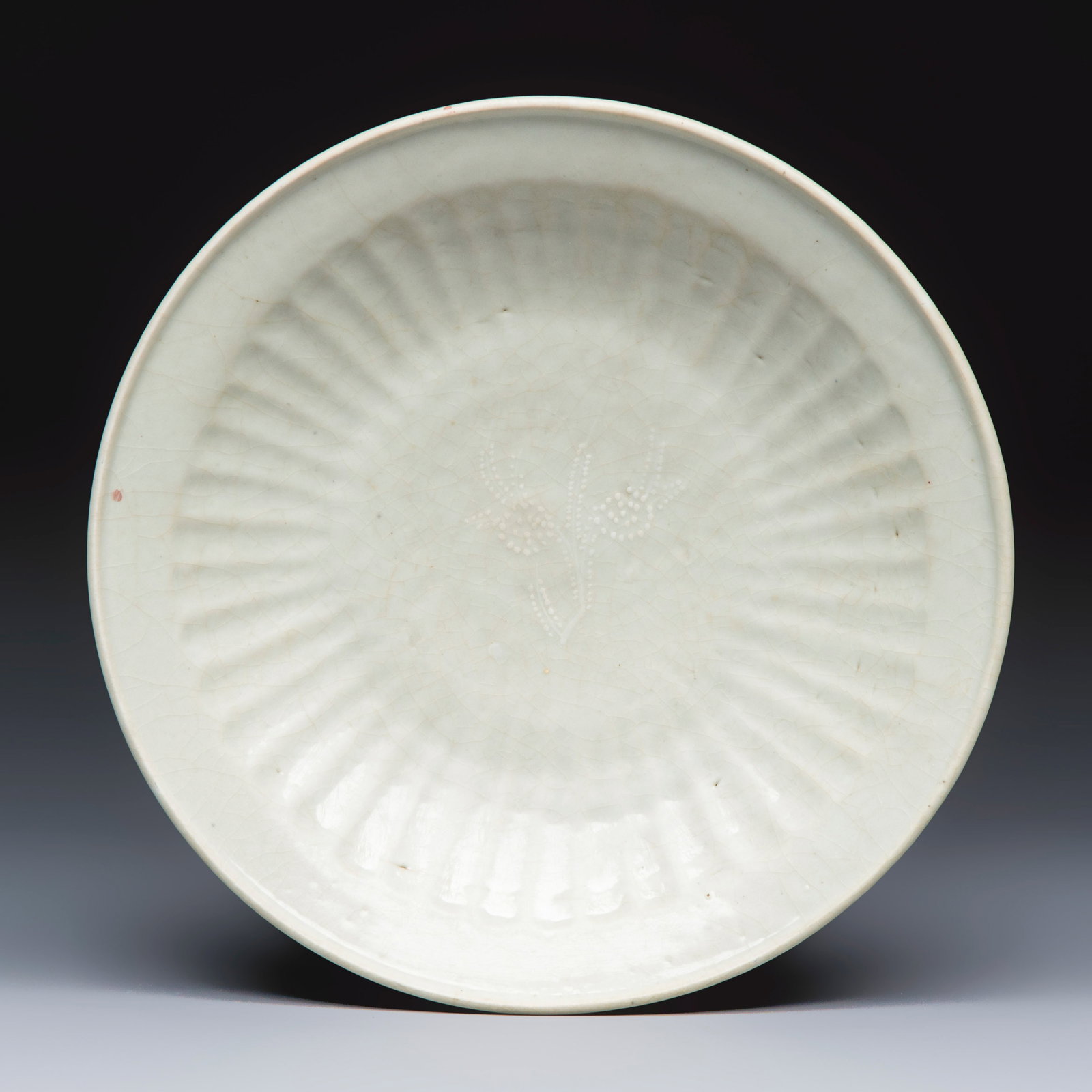 A Chinese Swatow slip-decorated white-ground dish, Ming (1 of 2)