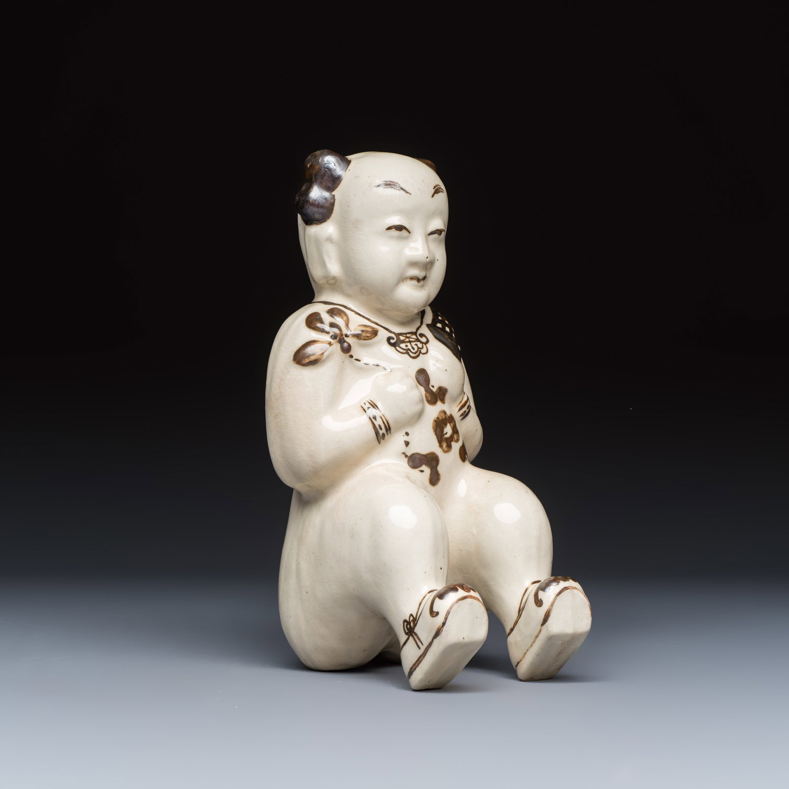 A Chinese Cizhou figure of a seated boy, probably Song (1 of 7)