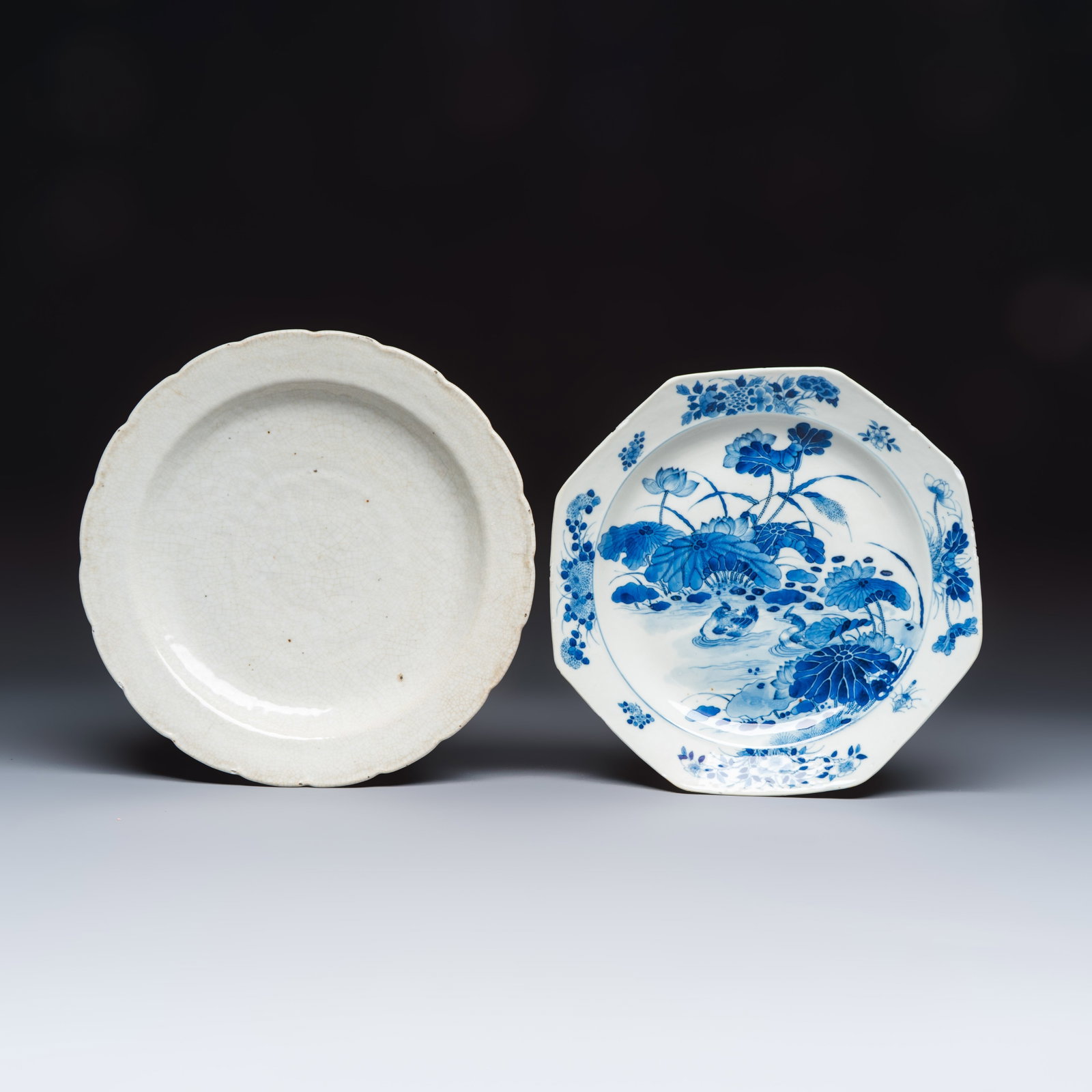 A Chinese blue and white 'Mandarin Duck' dish and a crackle-glazed dish, 19th C.: A Chinese blue and white 'Mandarin Duck' dish and a crackle-glazed dish, 19th C. Dia.: 32,3 cm | the largest Dia.: 30,6 cm | the smallest
