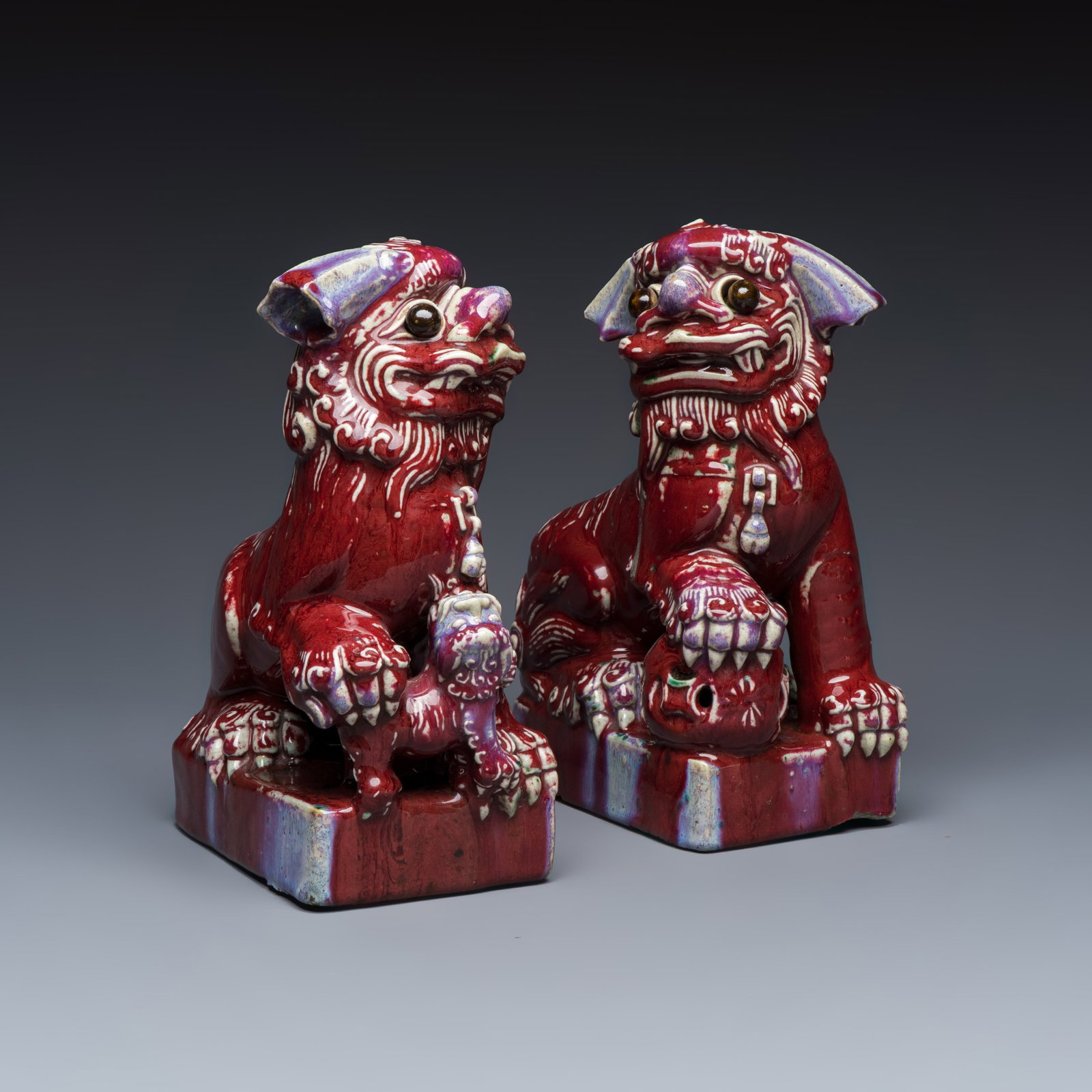 A pair of Chinese flambe-glazed models of Buddhist lions, 19th C. (1 of 7)