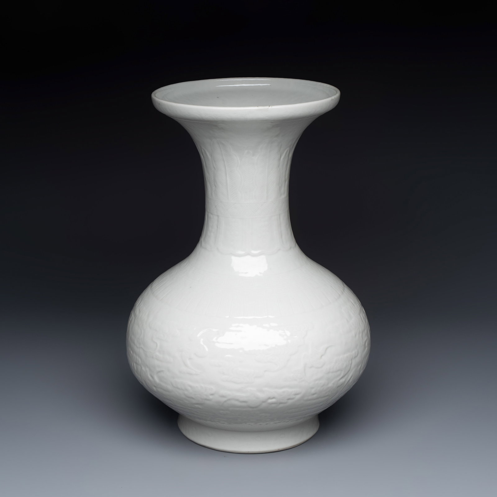 A Chinese white-glazed 'Bats among Clouds' vase with relief design, Qianlong/Jiaqing: A Chinese white-glazed 'Bats among Clouds' vase with relief design, Qianlong/Jiaqing H.: 37 cm