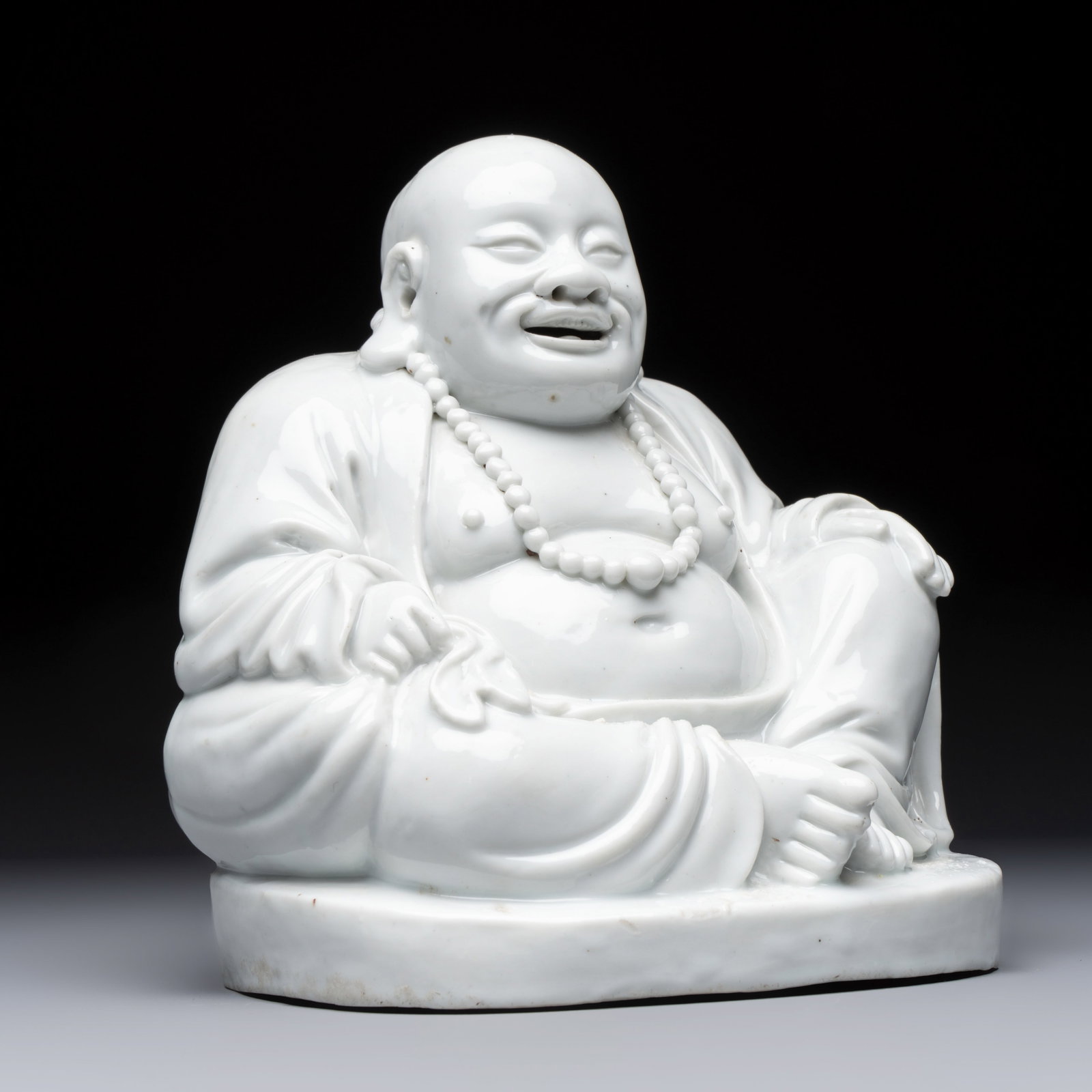 A Chinese Dehua blanc de Chine Milefo Buddha, 19th C. (1 of 7)