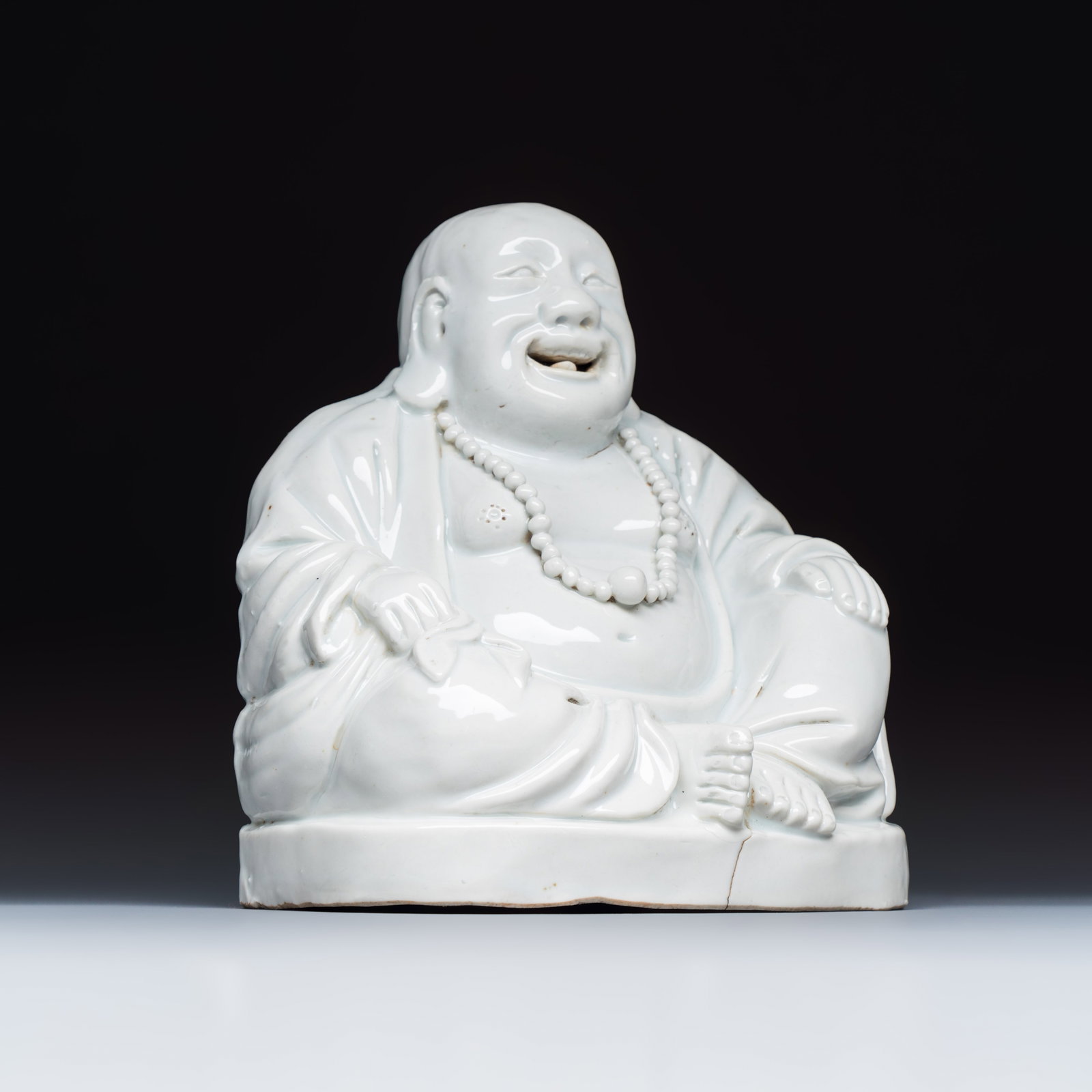 A Chinese white-glazed Milefo Buddha, 19th C.: A Chinese white-glazed Milefo Buddha, 19th C. Dim: 14,7 x 11 x 15,3 cm