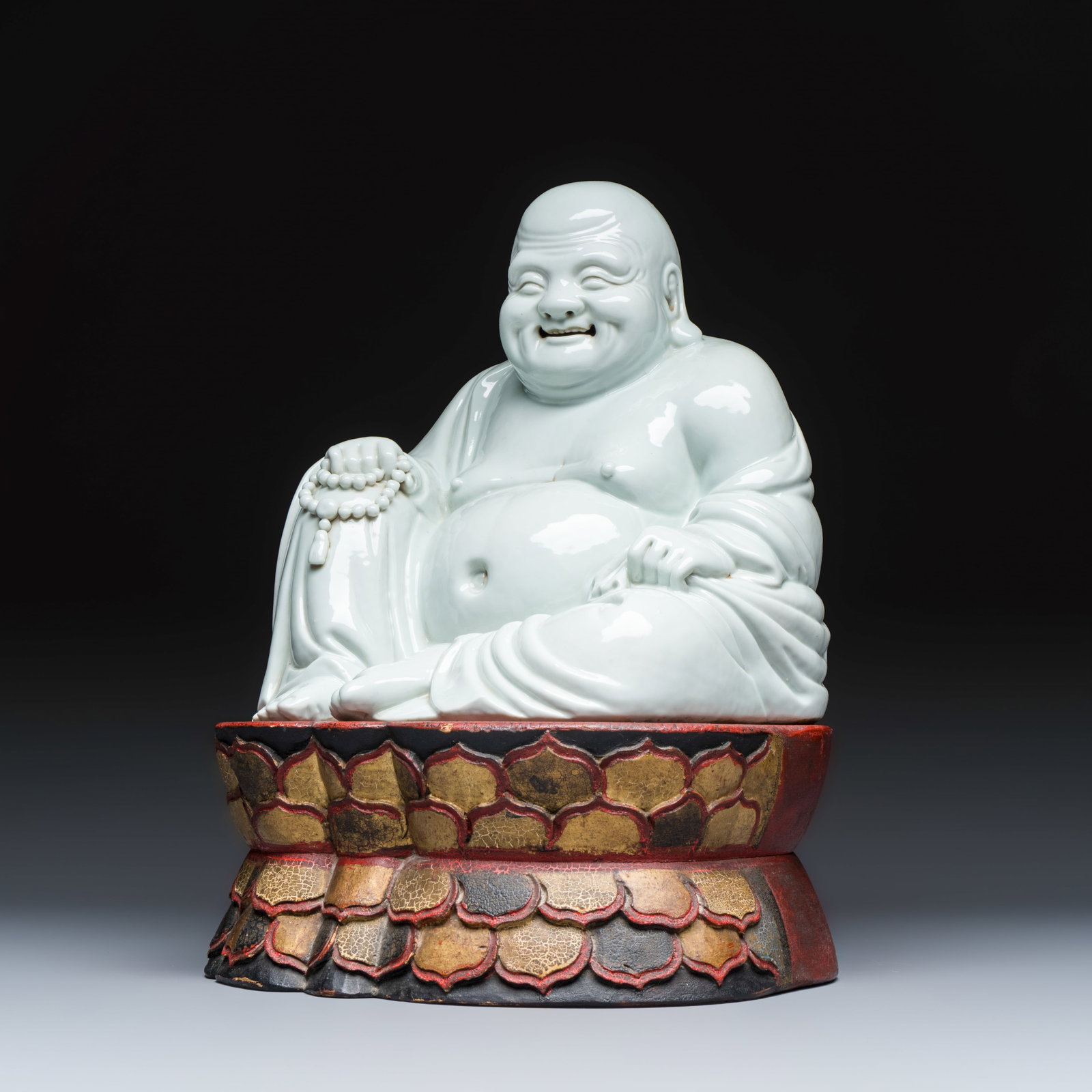A Chinese white-glazed Milefo Buddha on a gilt-lacquered wooden lotus throne, Republic (1 of 12)