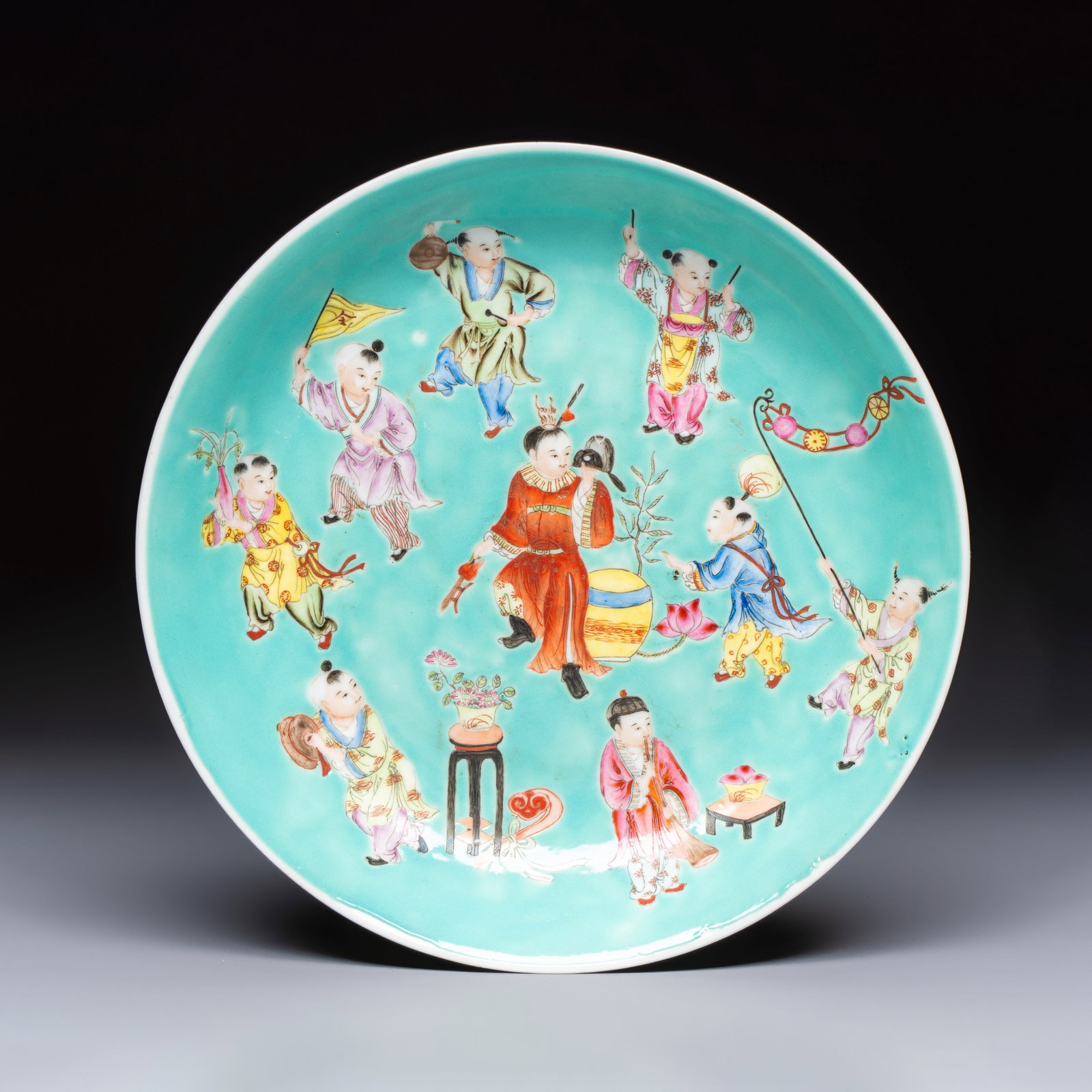 A Chinese famille rose turquoise-ground 'Playing Boys' plate, Qianlong mark, Republic: A Chinese famille rose turquoise-ground 'Playing Boys' plate, Qianlong mark, Republic Dia.: 23,5 cm