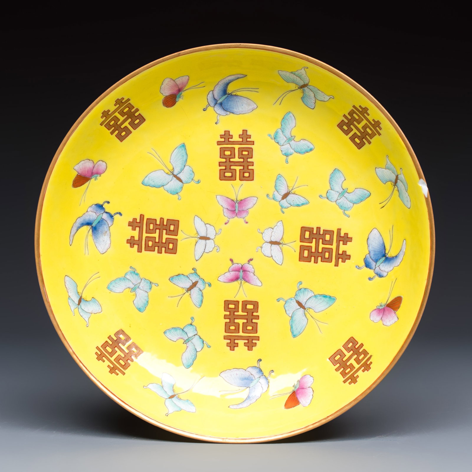 A Chinese famille rose yellow-ground 'Double Happiness and Butterflies' plate, Tongzhi mark, (1 of 2)